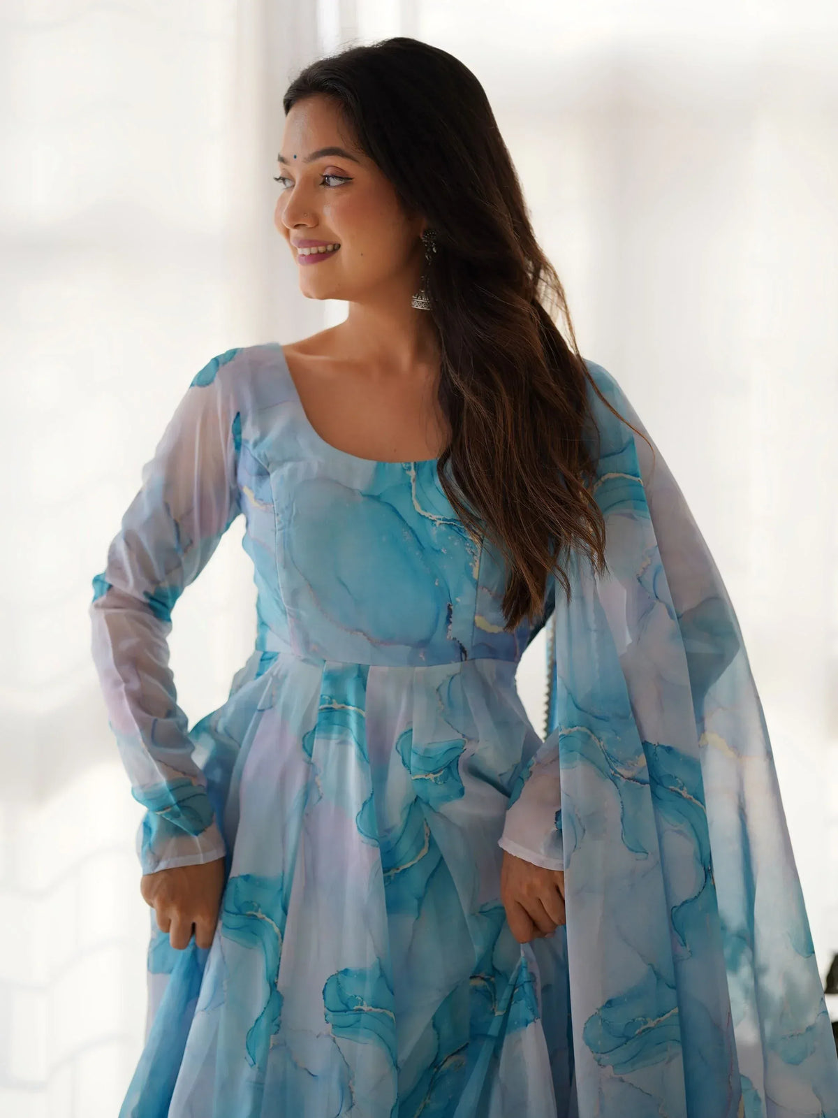 Blue and white abstract print ethnic gown with flared sleeves, perfect for festive occasions.