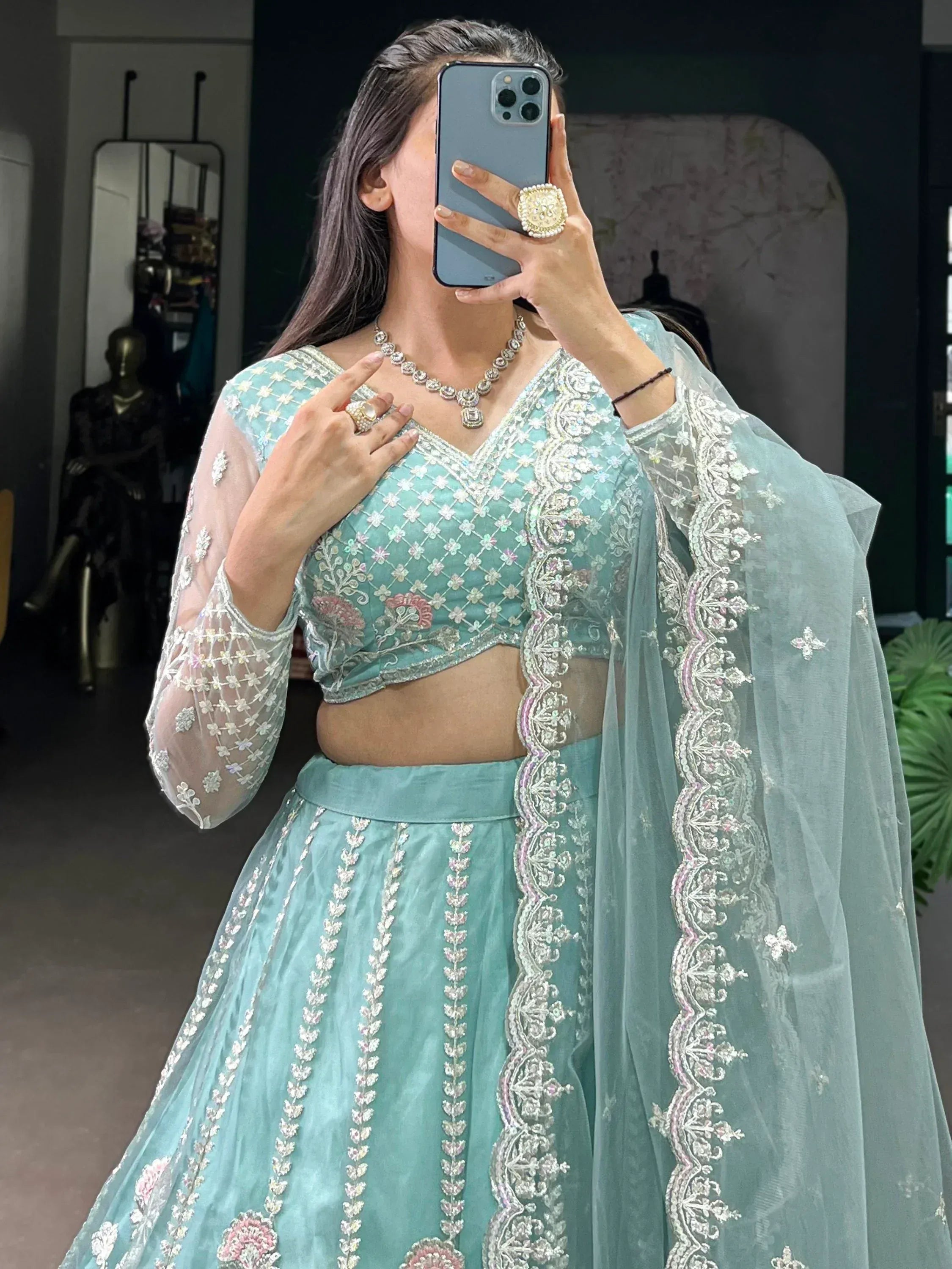 Mint green embroidered lehenga choli with sheer dupatta, perfect for Indian weddings and festive occasions.