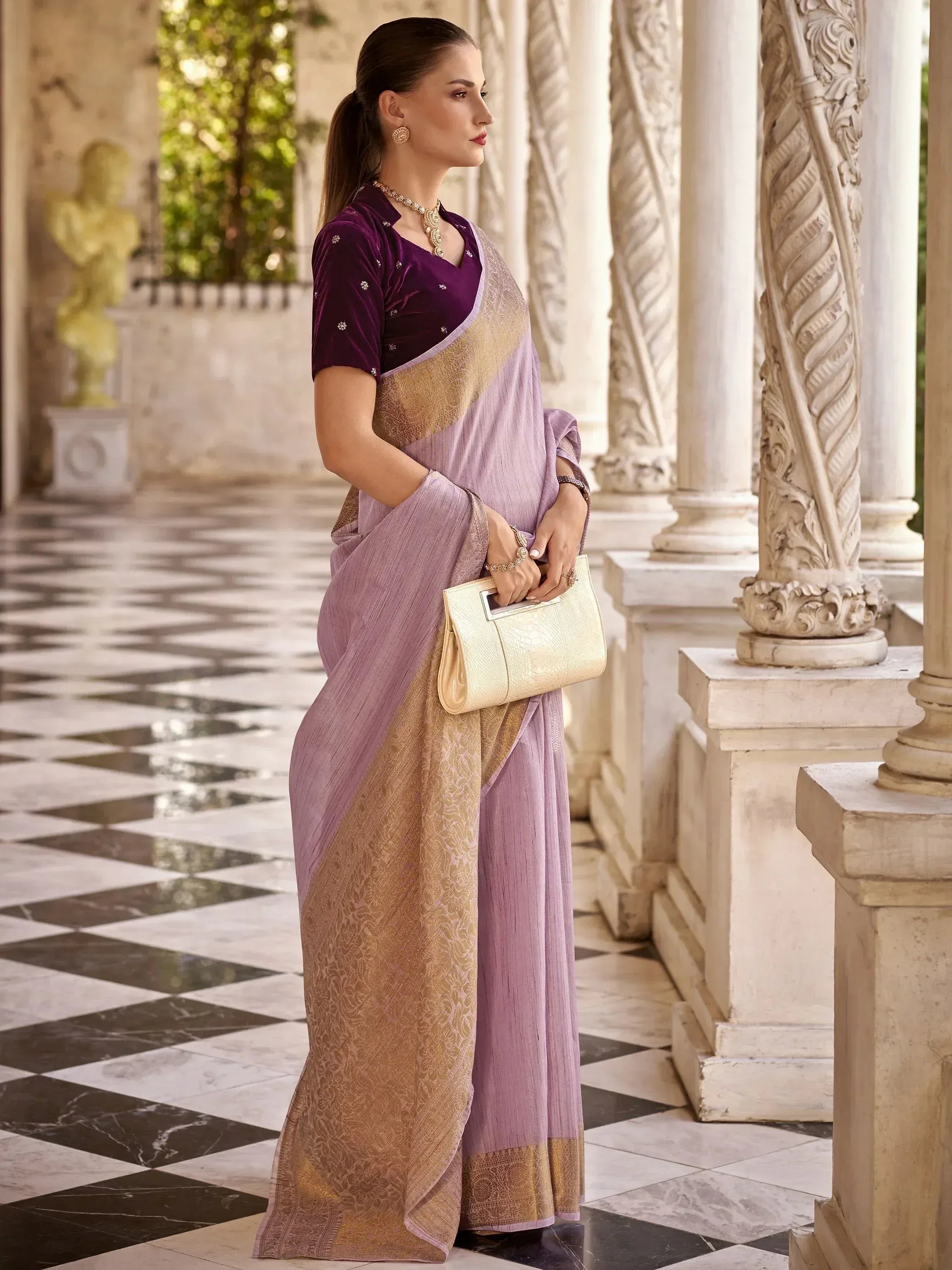 Woman in purple velvet blouse with lavender and gold saree, elegant ethnic wear for special occasions