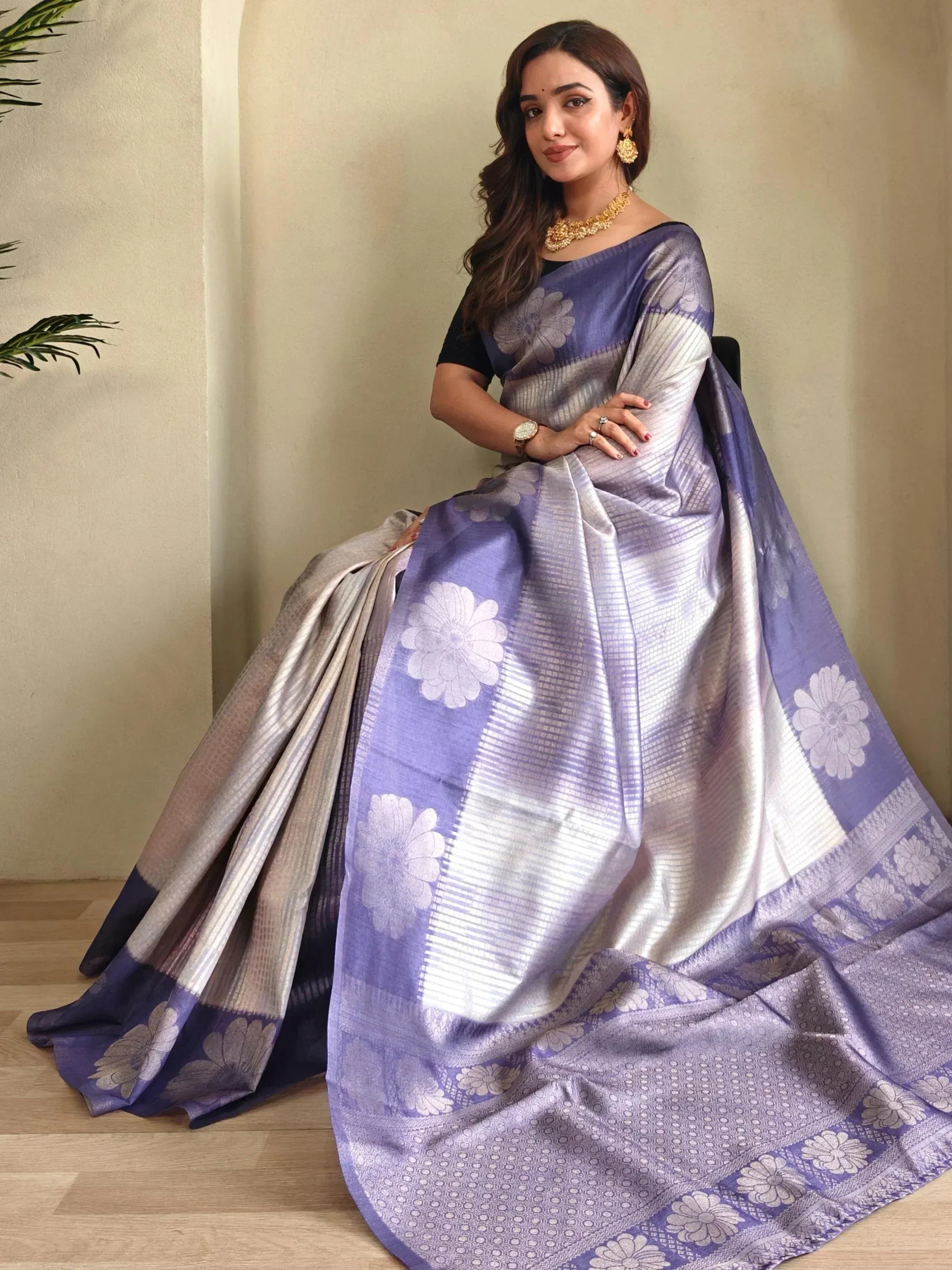 Woman in purple and silver floral saree with gold jewelry, Indian ethnic wear