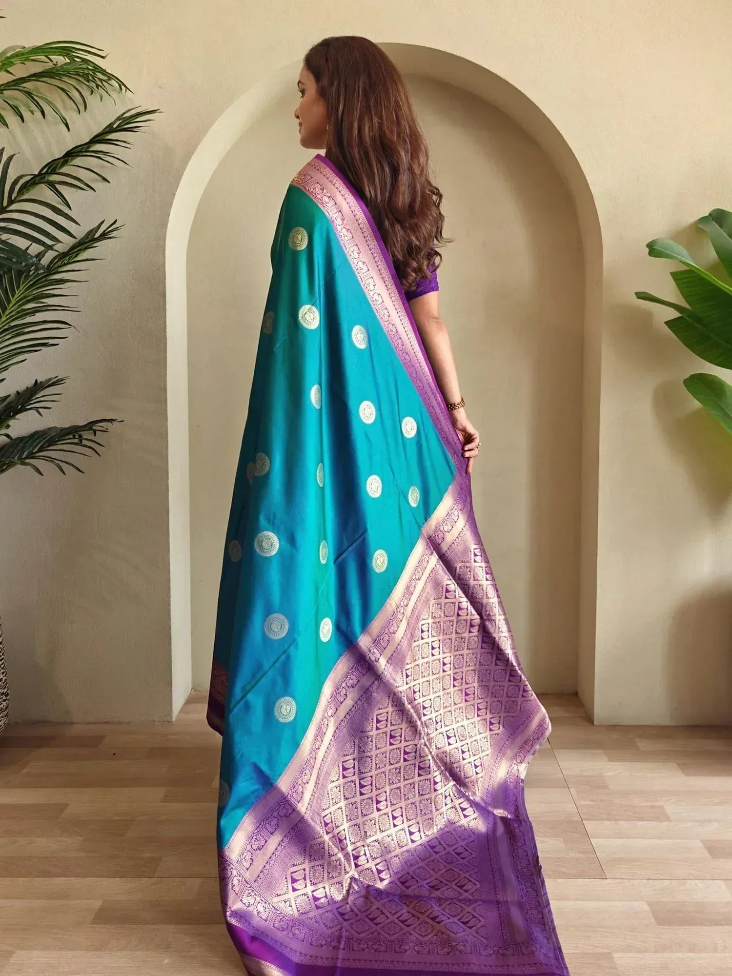 Teal and purple designer saree with gold motifs and woven border, styled for ethnic occasions