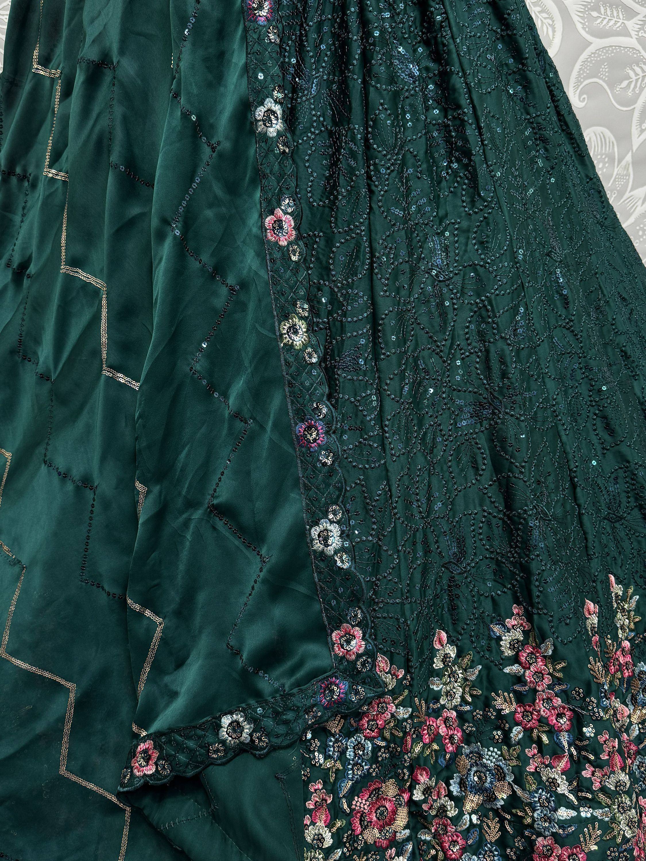 Emerald green ethnic gown with floral embroidery and sequin detailing, perfect for Indian occasions