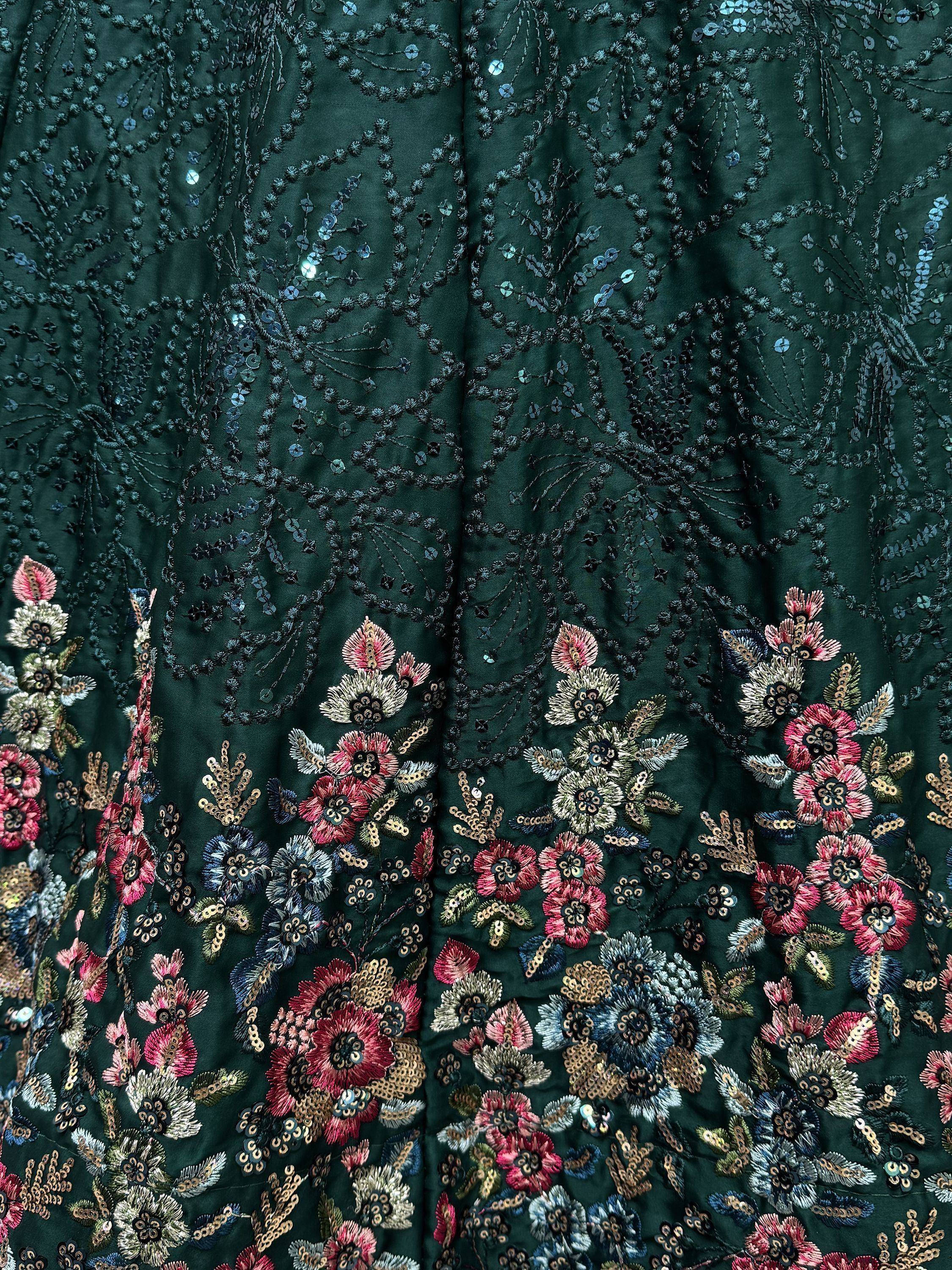 Dark green ethnic gown with floral embroidery and sequin detailing for festive occasions