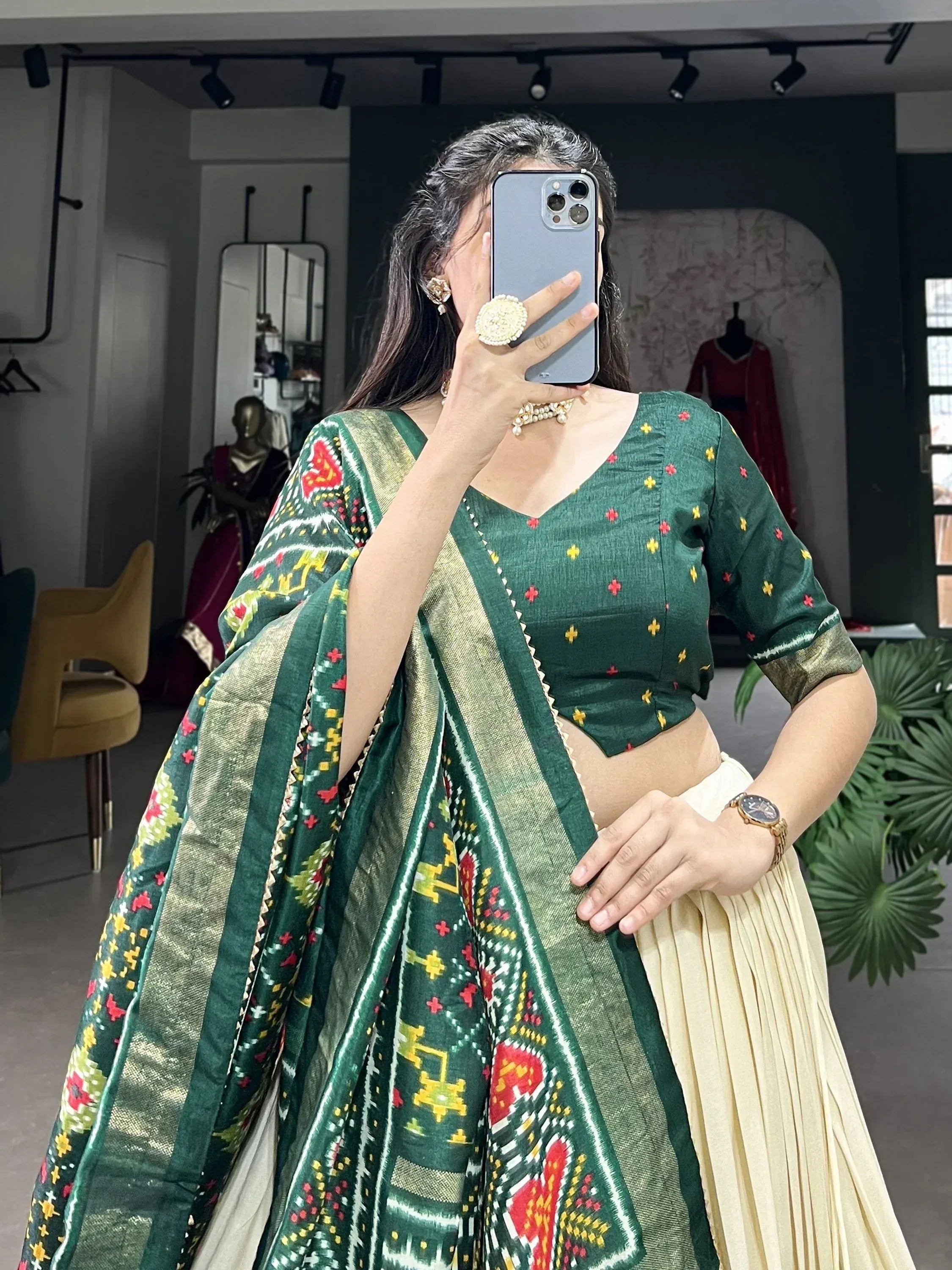 Green embroidered blouse with ikat dupatta, cream pleated skirt, Indian ethnic wear