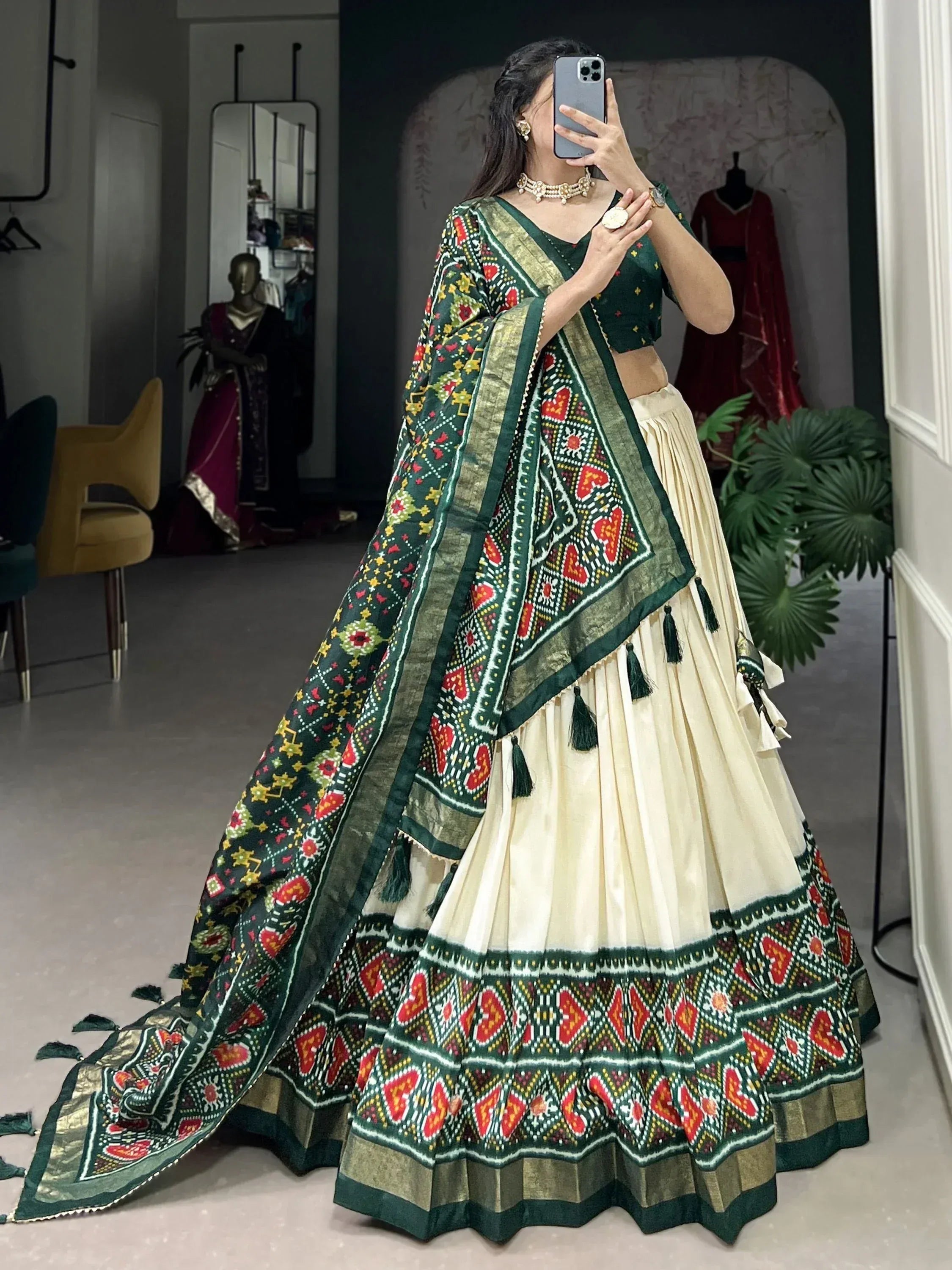 Green and cream embroidered lehenga choli with heart motifs and tassels, perfect for Indian ethnic wear