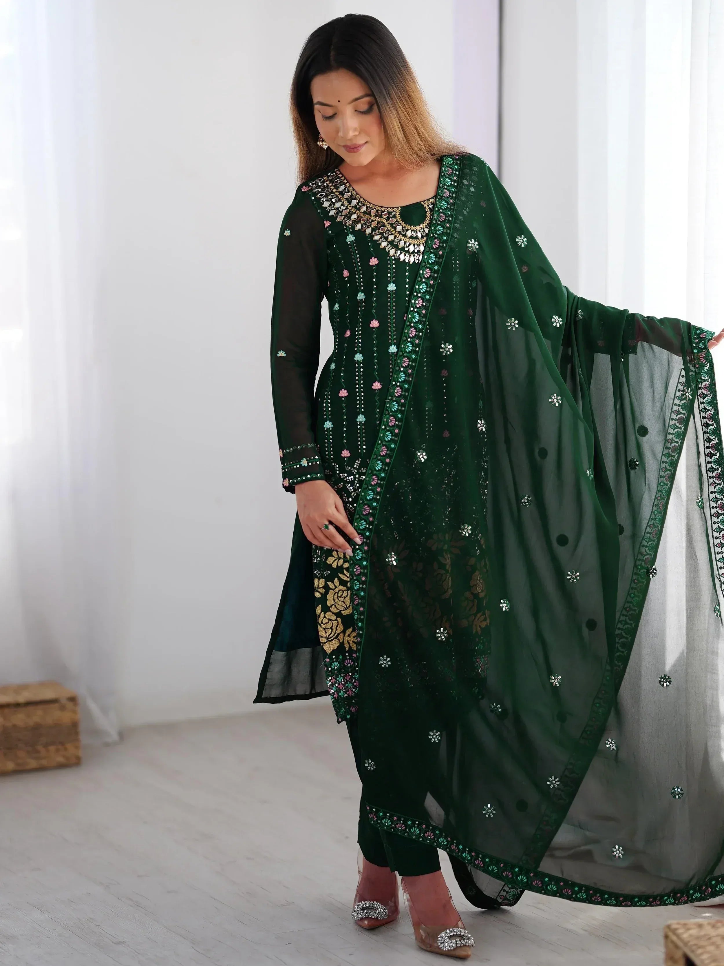 Emerald green embroidered salwar kameez with sheer dupatta, floral embellishments, and gold detailing for ethnic wear