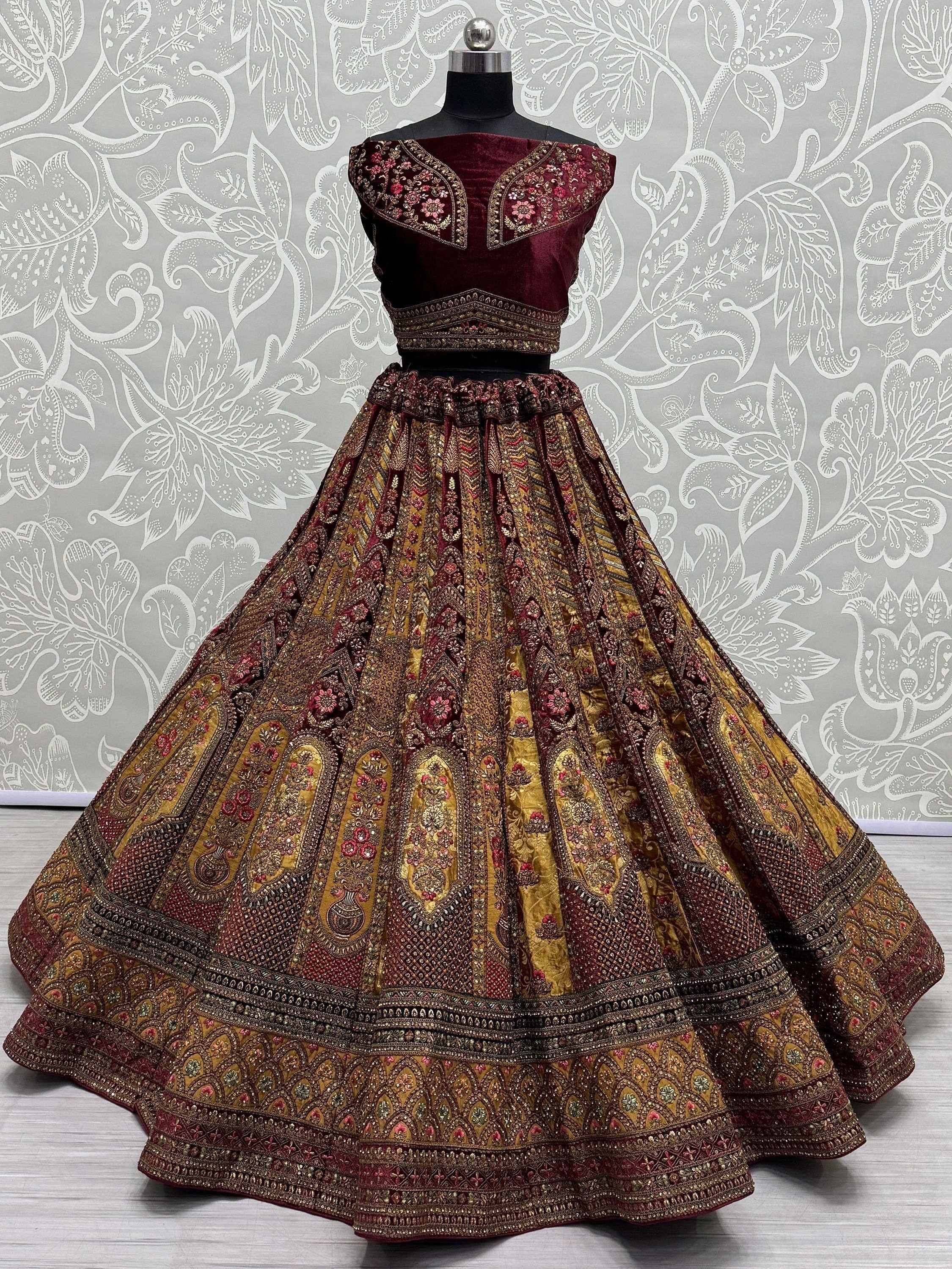 Maroon and gold embroidered lehenga choli with floral motifs, displayed on mannequin for Indian ethnic wear