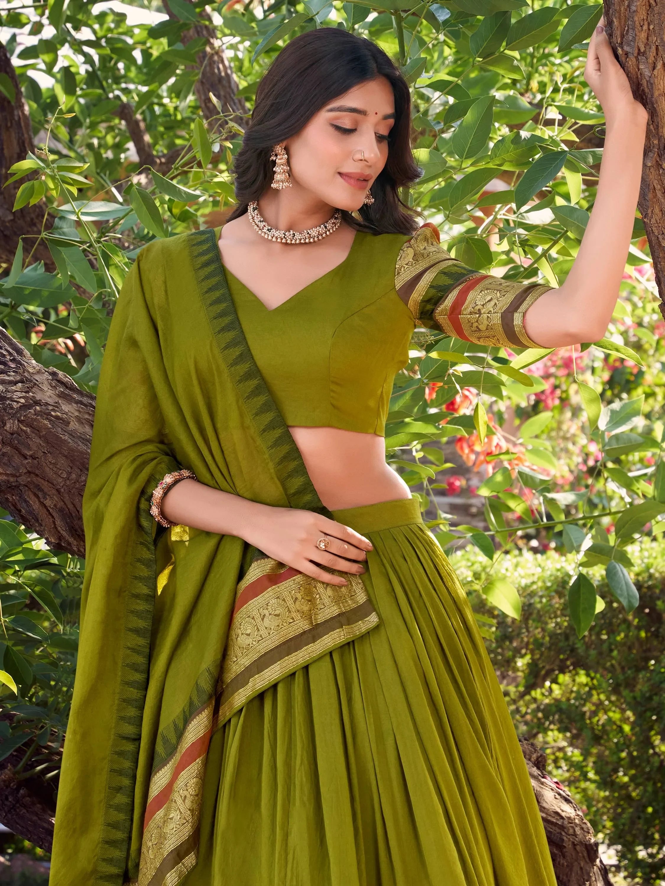 Olive green designer lehenga choli with gold embroidery, perfect for Indian ethnic wear occasions.