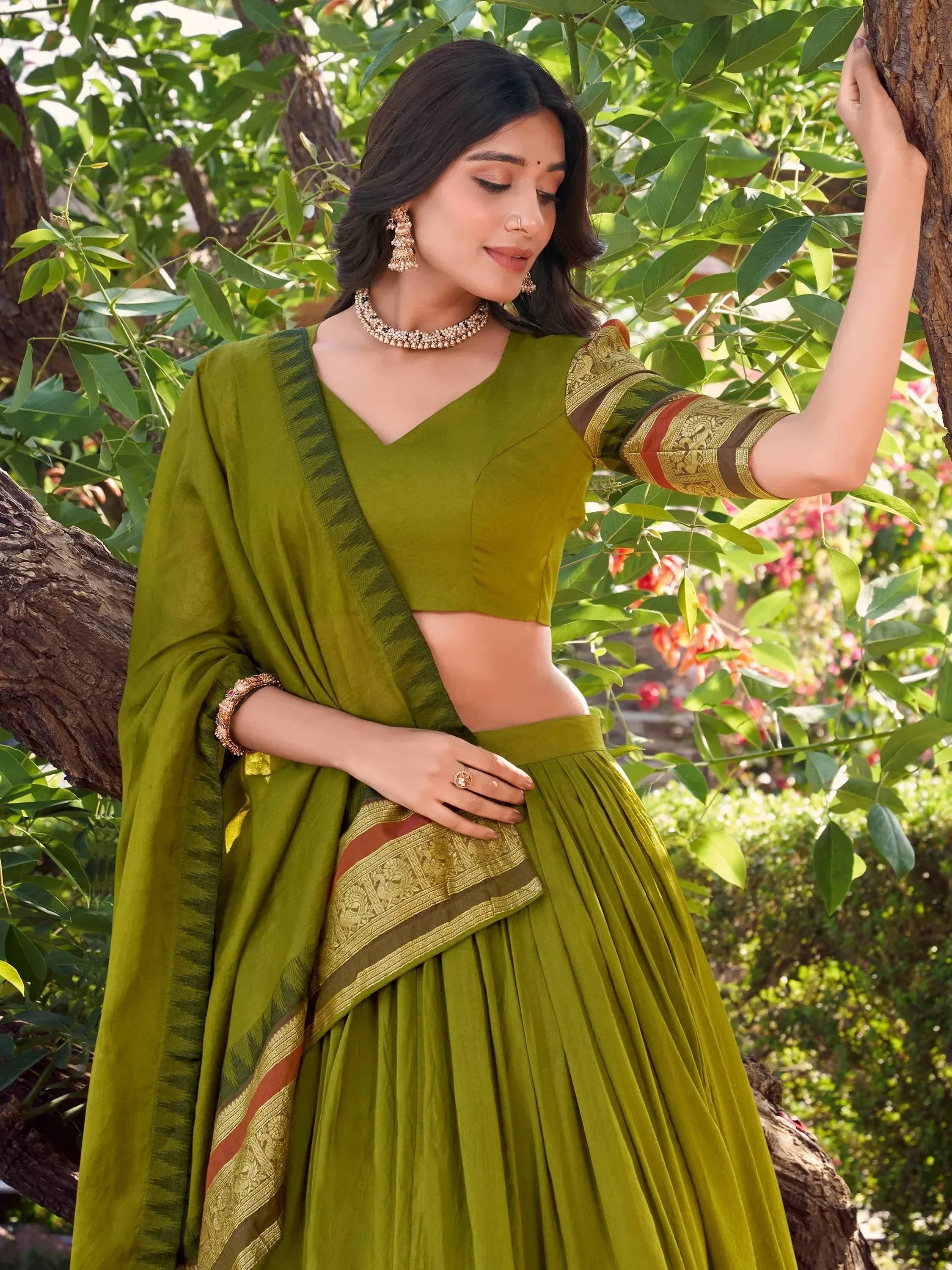 Olive green designer lehenga choli with gold embroidery, perfect for Indian ethnic wear occasions.