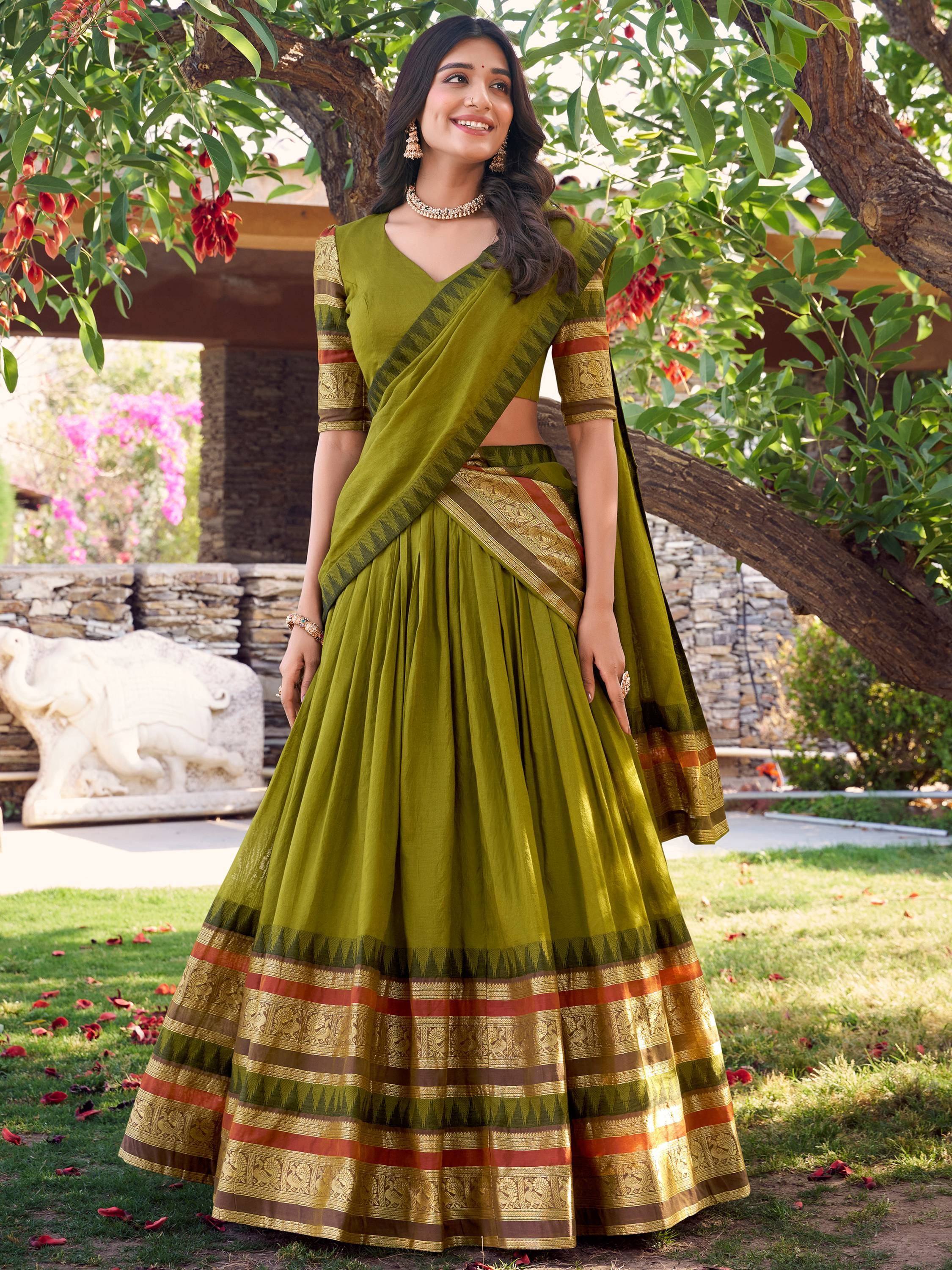 Olive green designer lehenga choli with gold and red border, perfect for Indian ethnic wear occasions.
