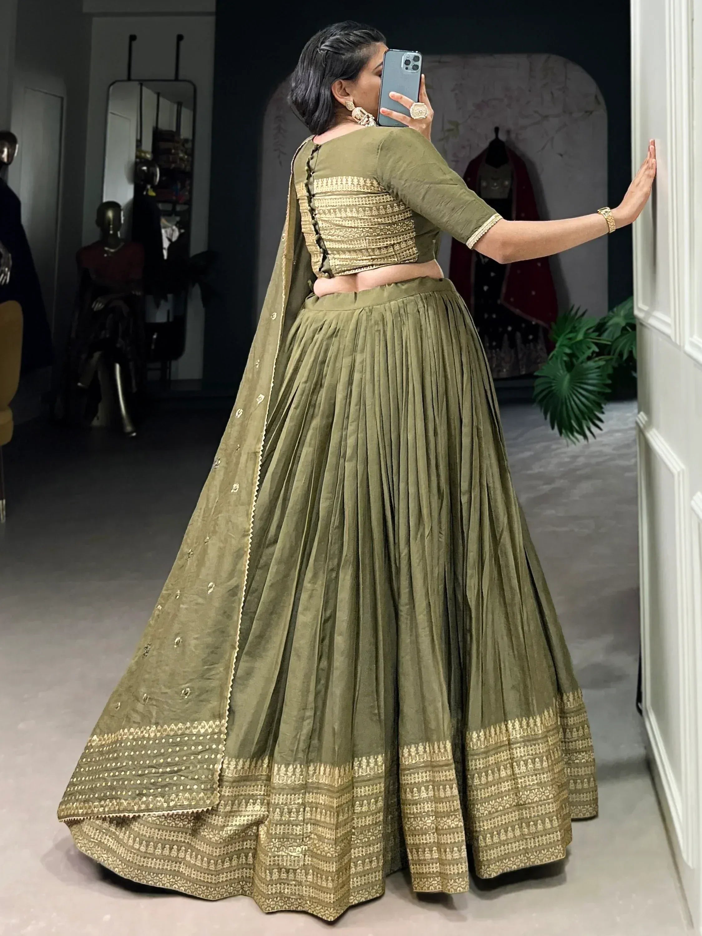 Olive green designer lehenga choli with gold embroidery, pleated skirt, and matching dupatta for Indian ethnic wear