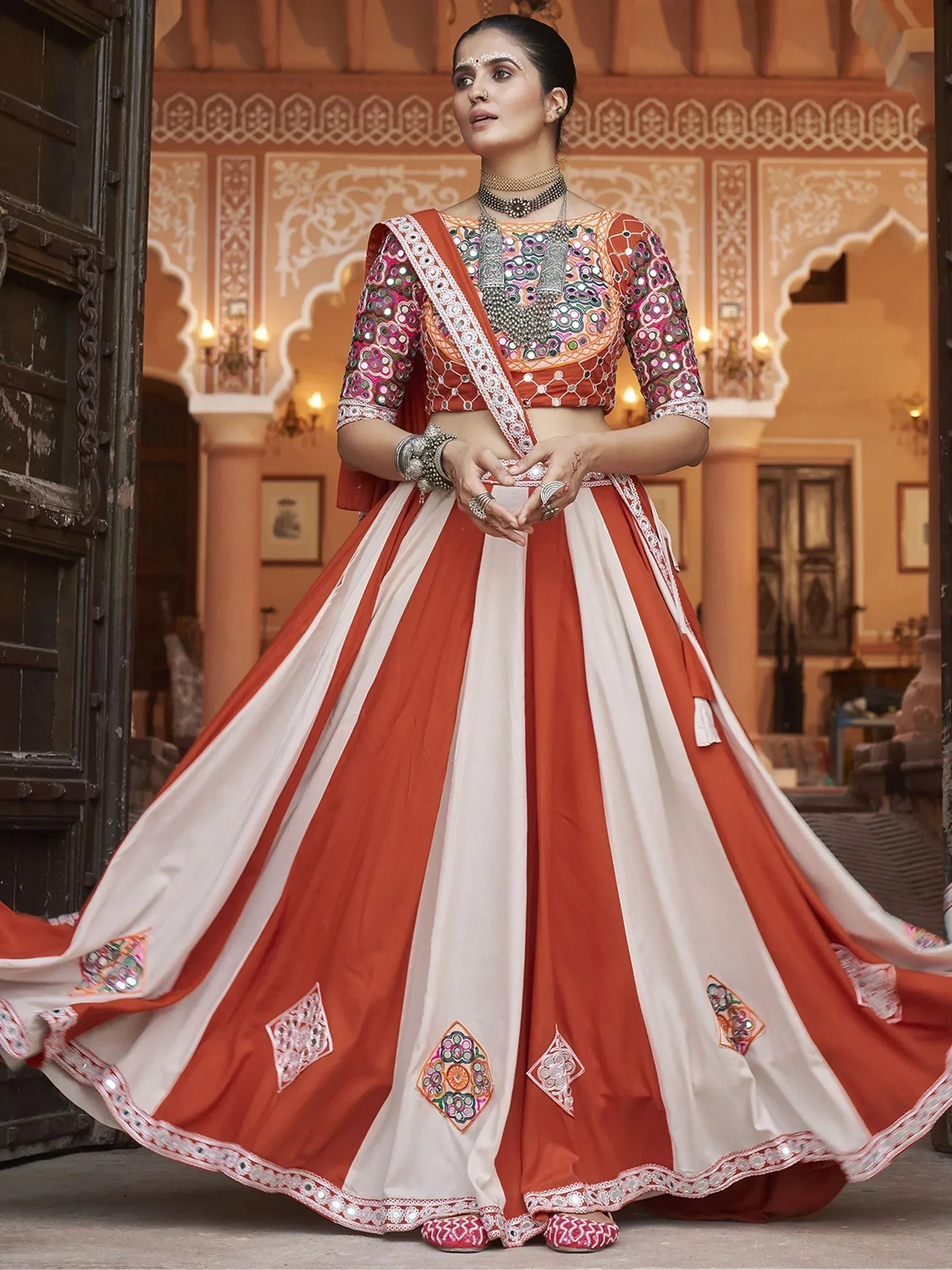 Orange and white embroidered lehenga choli with mirror work, perfect for Indian ethnic wear occasions