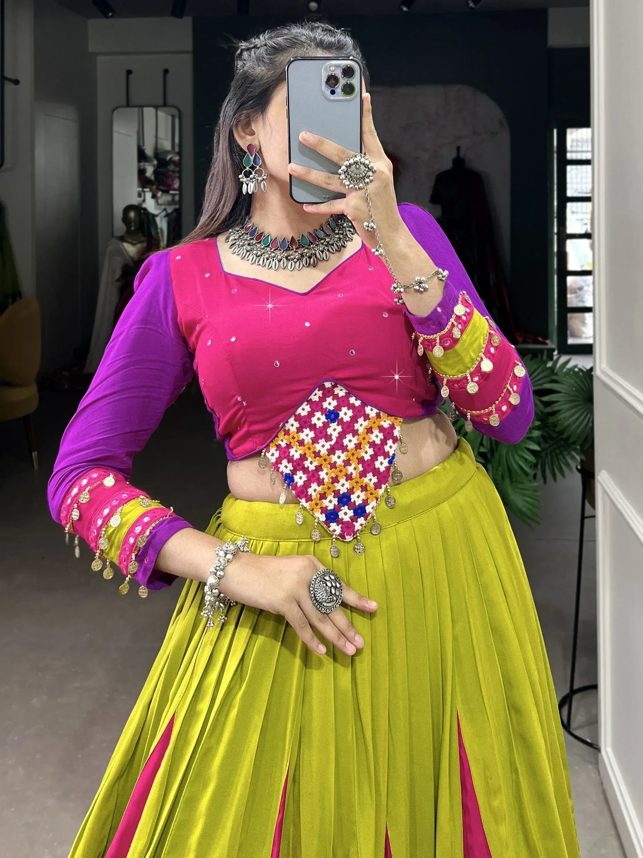 Vibrant pink and purple crop top with embroidered dupatta, paired with lime green pleated skirt, traditional Indian ethnic wear