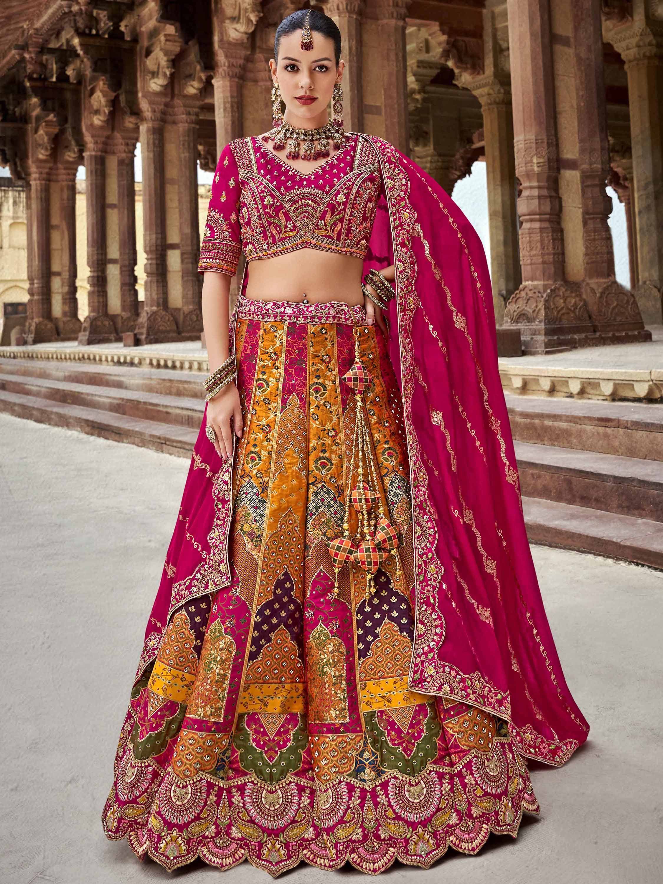 Elegant magenta and gold embroidered lehenga choli with intricate patchwork, perfect for Indian weddings and festive occasions.