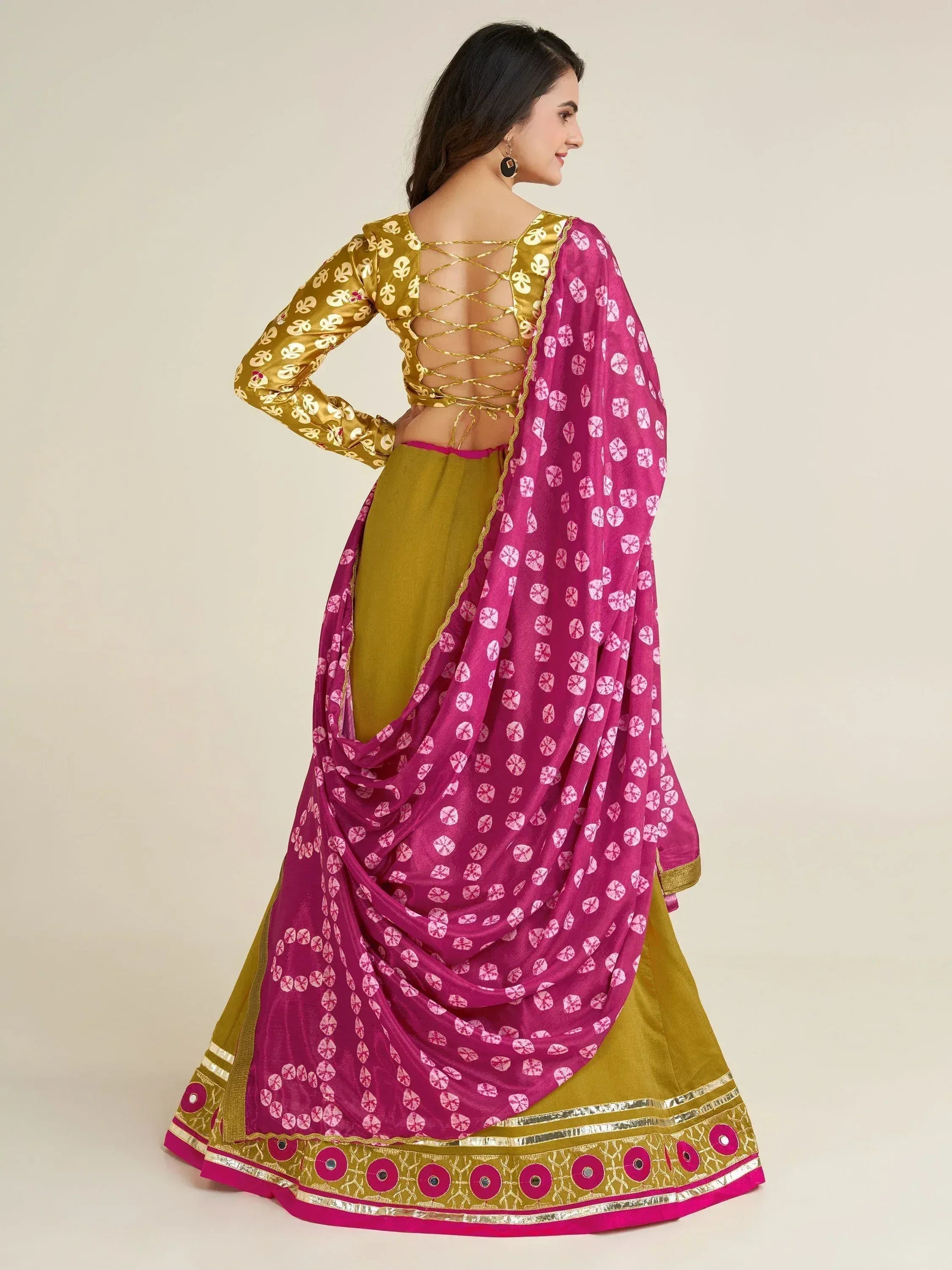 Elegant Indian ethnic lehenga choli with gold lace-up back and pink patterned dupatta