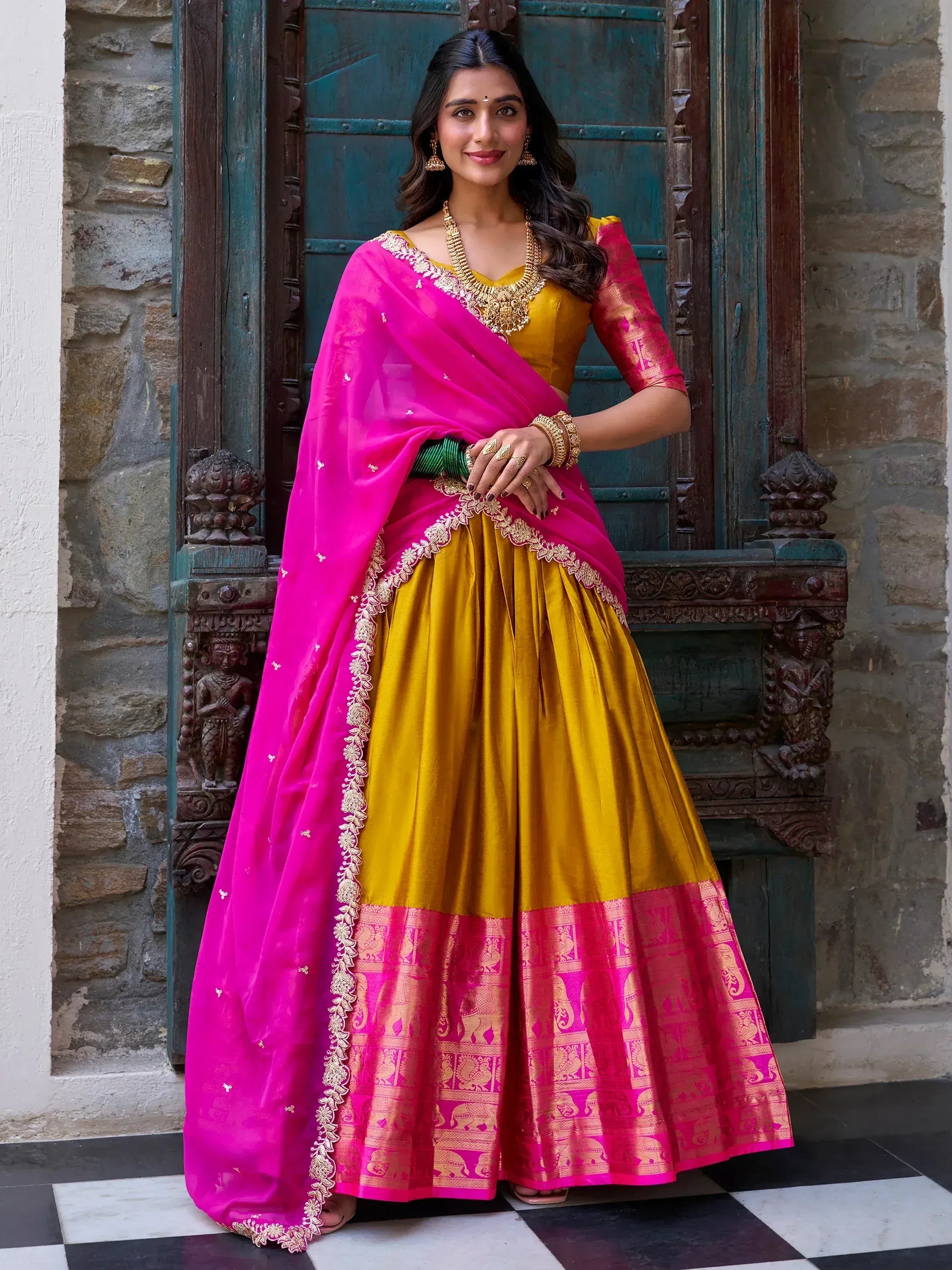 Yellow and pink designer lehenga choli with gold embroidery, perfect for Indian ethnic wear occasions.