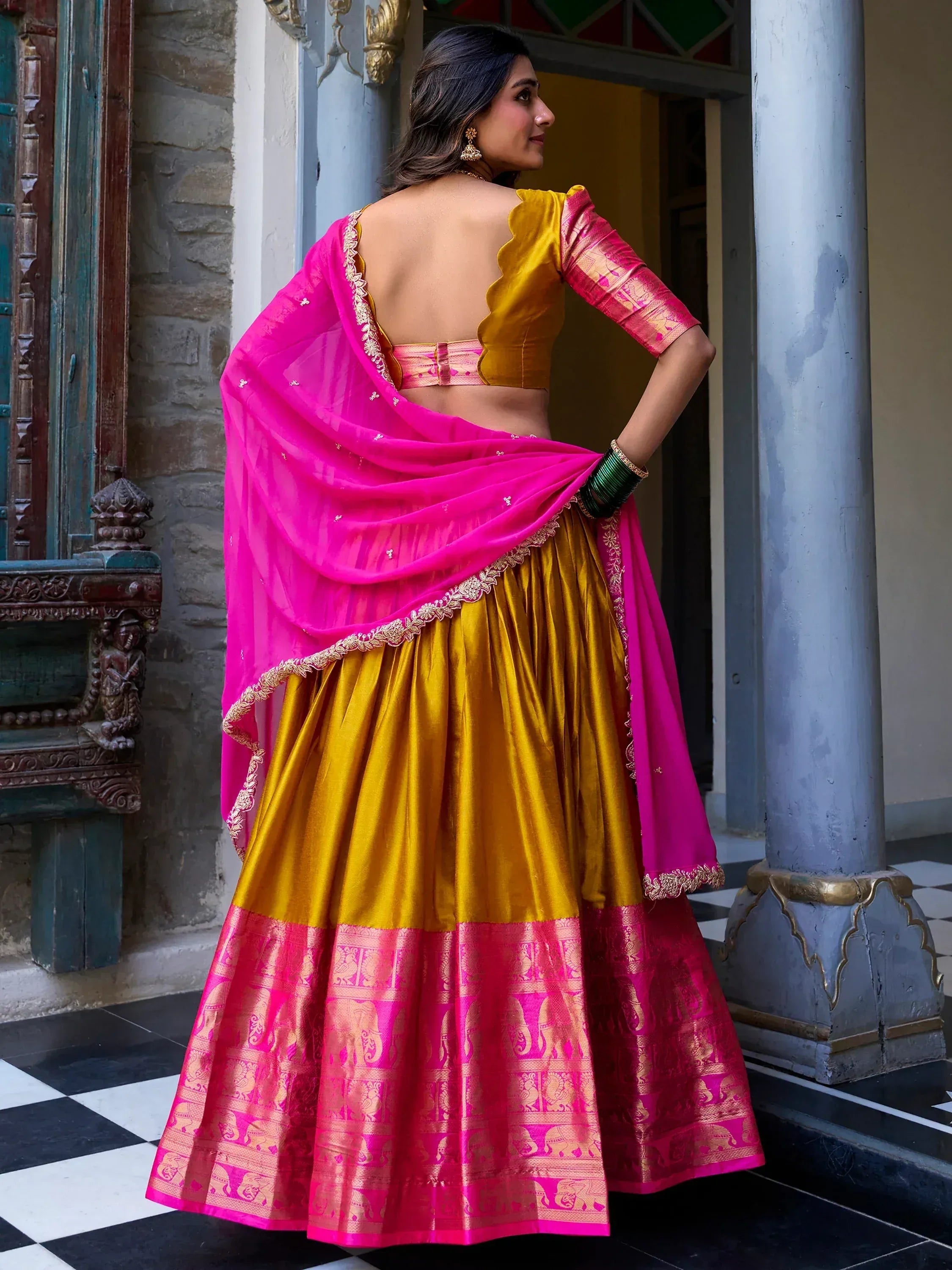 Vibrant pink and gold lehenga choli with embroidered dupatta, perfect for Indian ethnic occasions