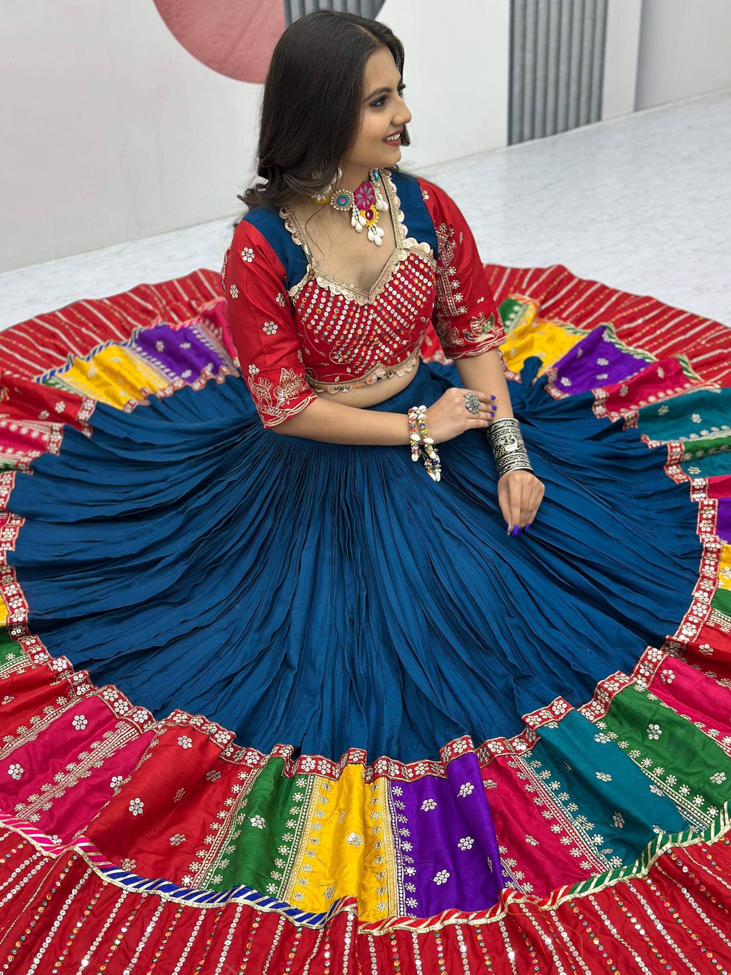 Vibrant blue and red lehenga choli with colorful patchwork and mirror work, perfect for festive occasions.