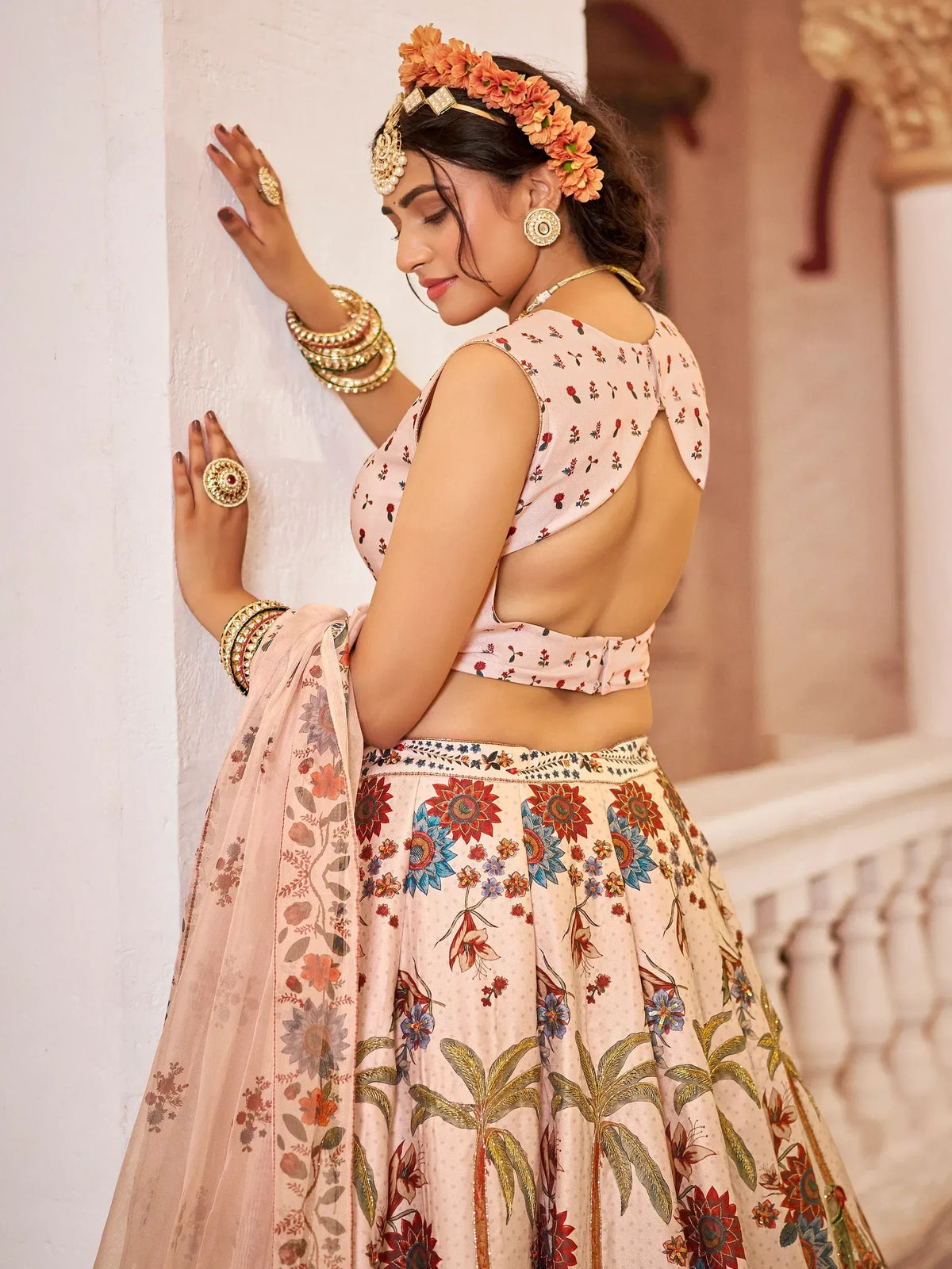 Woman in floral print lehenga choli with backless blouse, traditional Indian ethnic wear