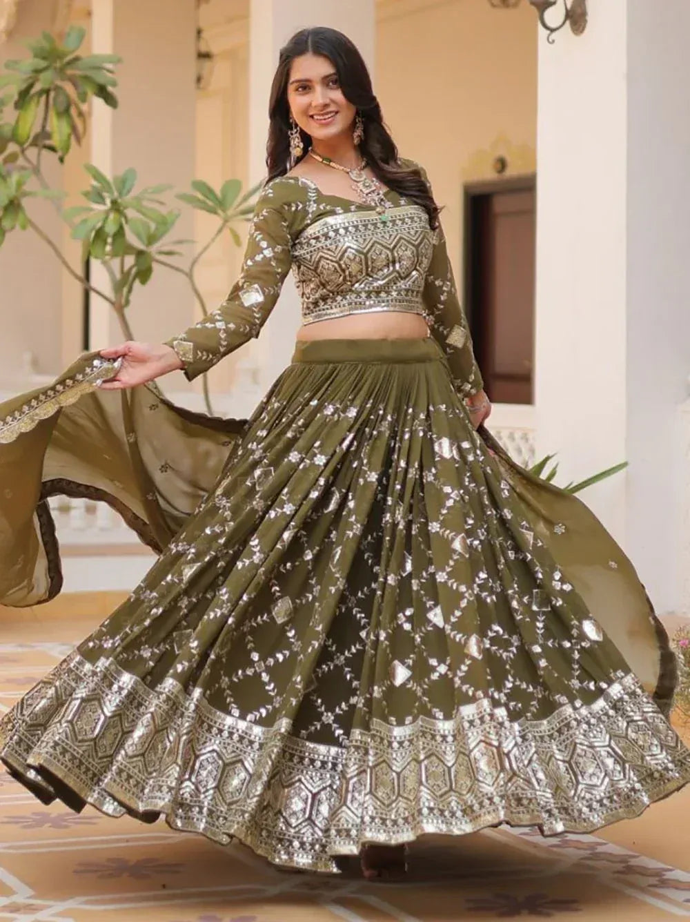 Olive green designer lehenga choli with silver embroidery, perfect for Indian ethnic wear occasions.