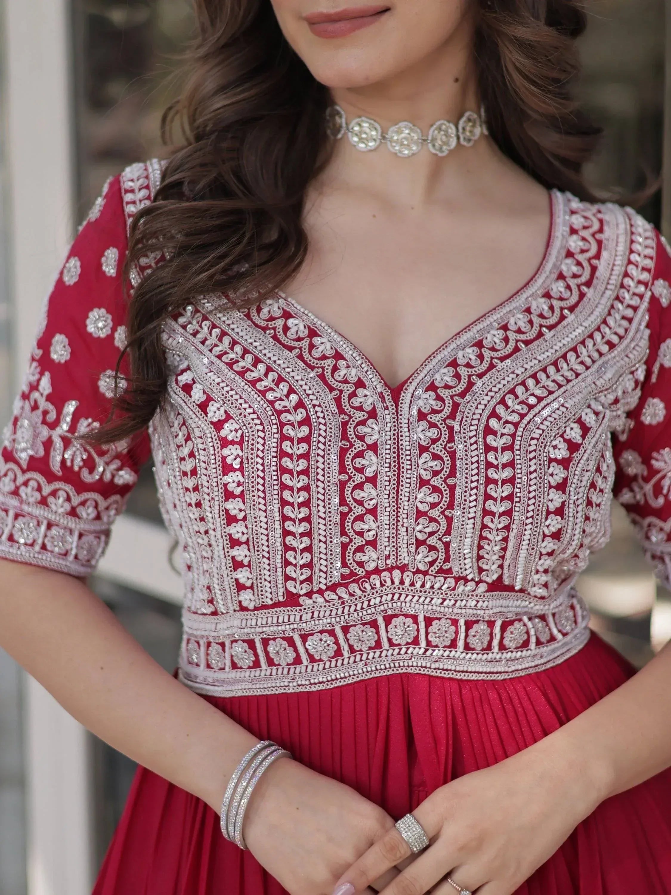 Red embroidered ethnic gown with silver detailing, perfect for Indian festive occasions and weddings