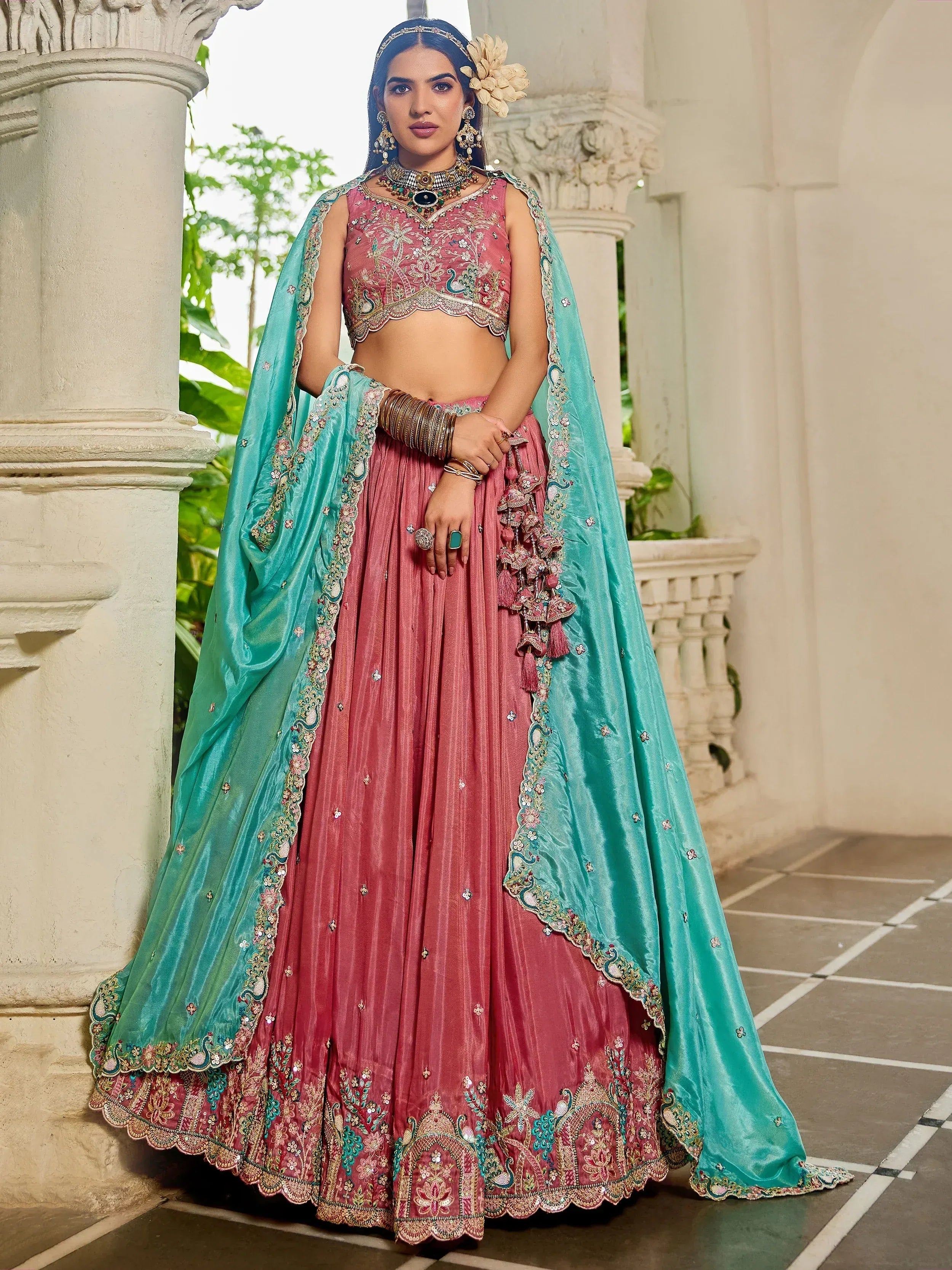 Pink and turquoise embroidered lehenga choli with peacock motifs, perfect for Indian weddings and festive occasions.