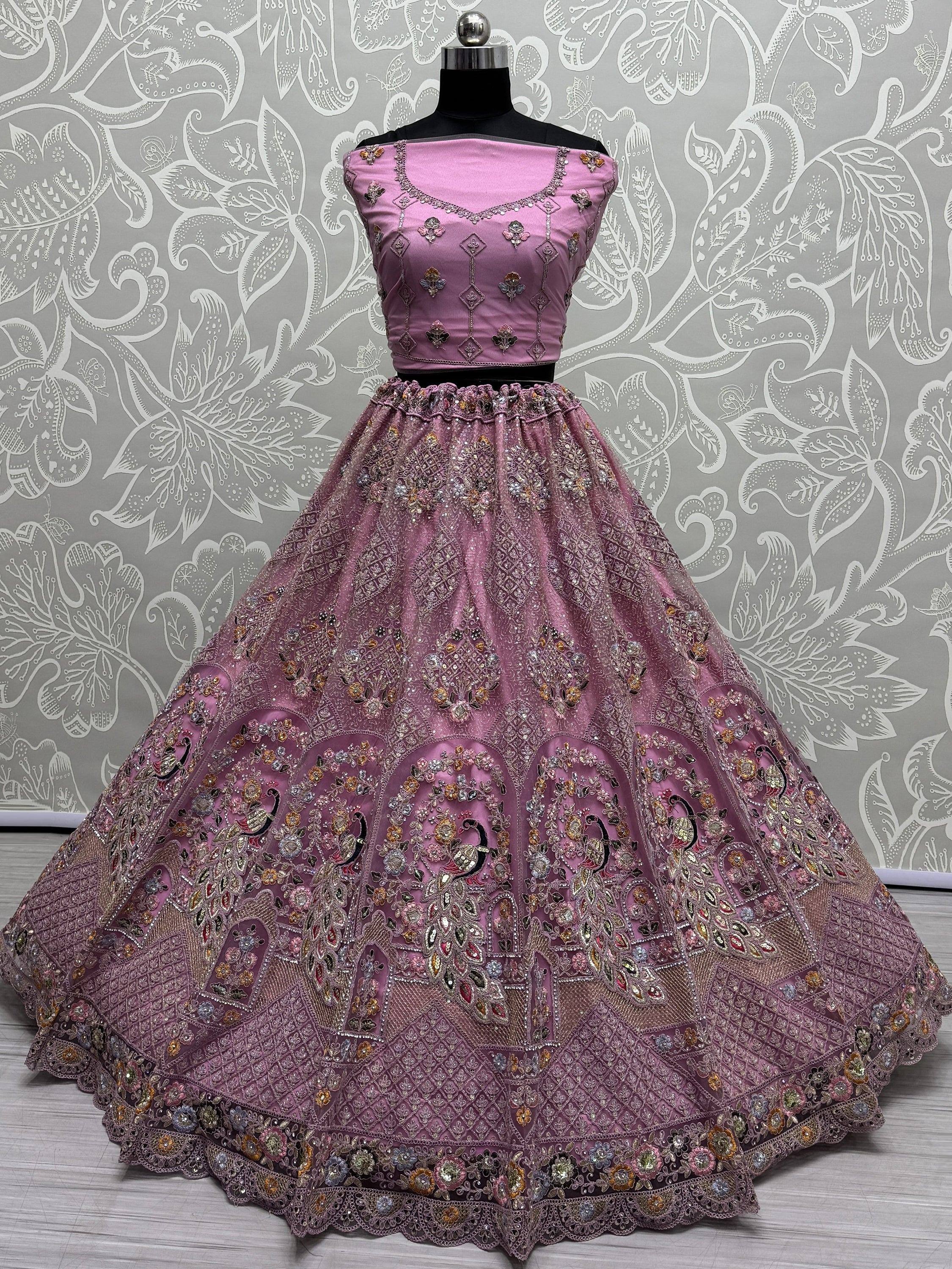 Pink designer lehenga choli with intricate embroidery and peacock motifs, perfect for Indian ethnic wear.