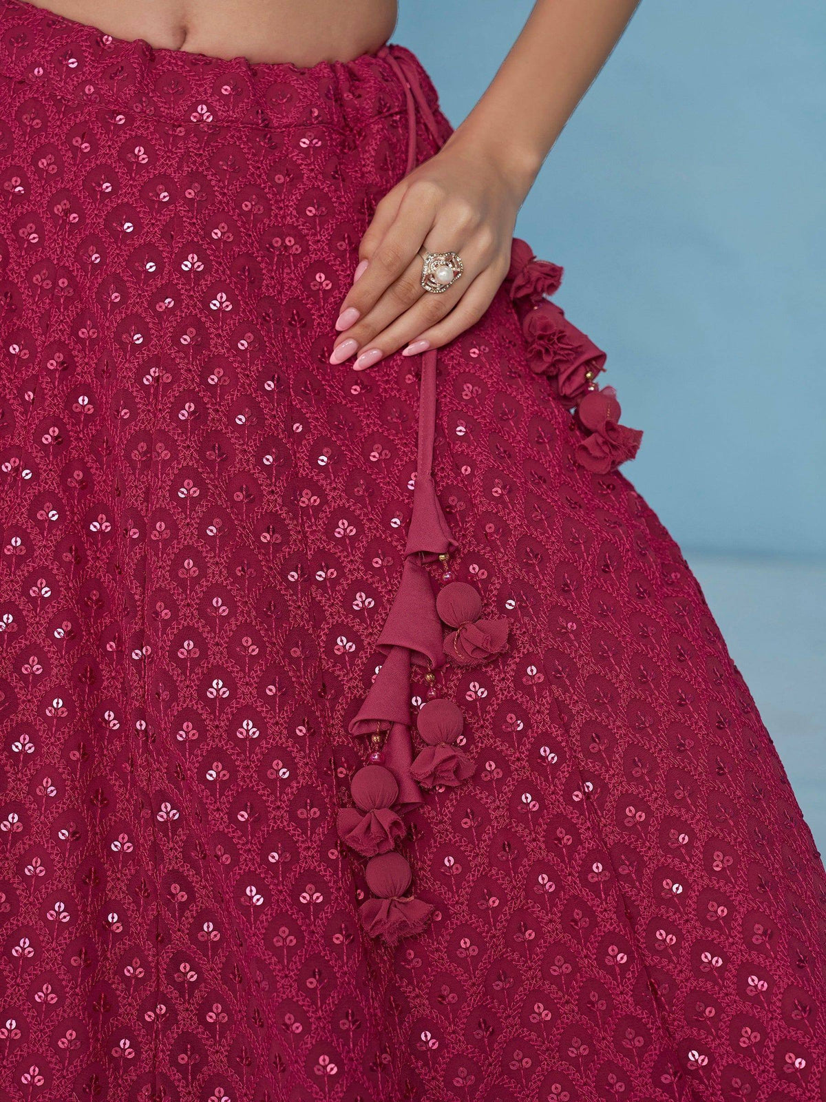 Burgundy sequin lehenga with floral embroidery and tassel details, perfect for Indian ethnic wear