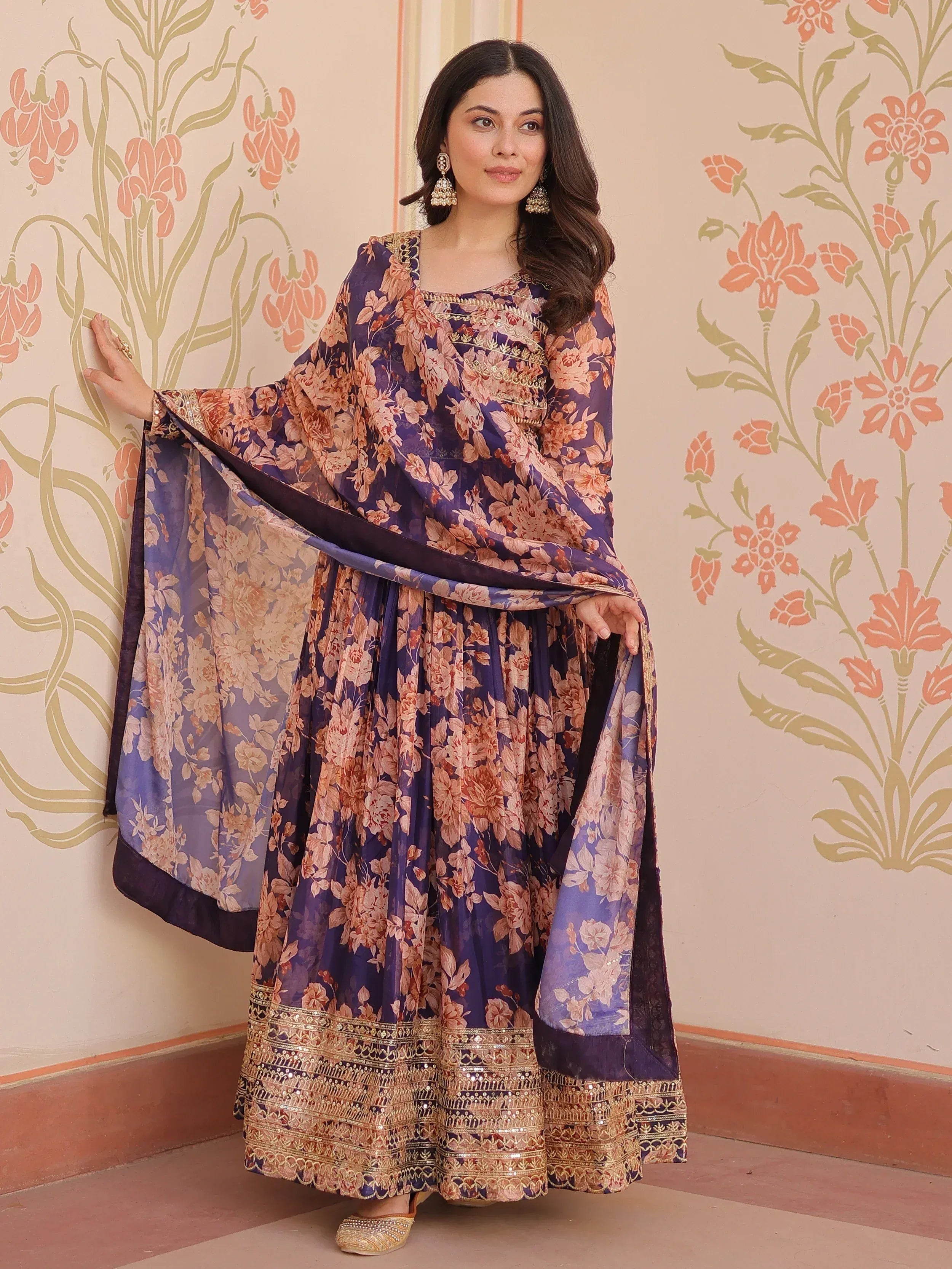 Purple floral printed ethnic gown with gold embroidery, perfect for Indian occasions and festive wear.