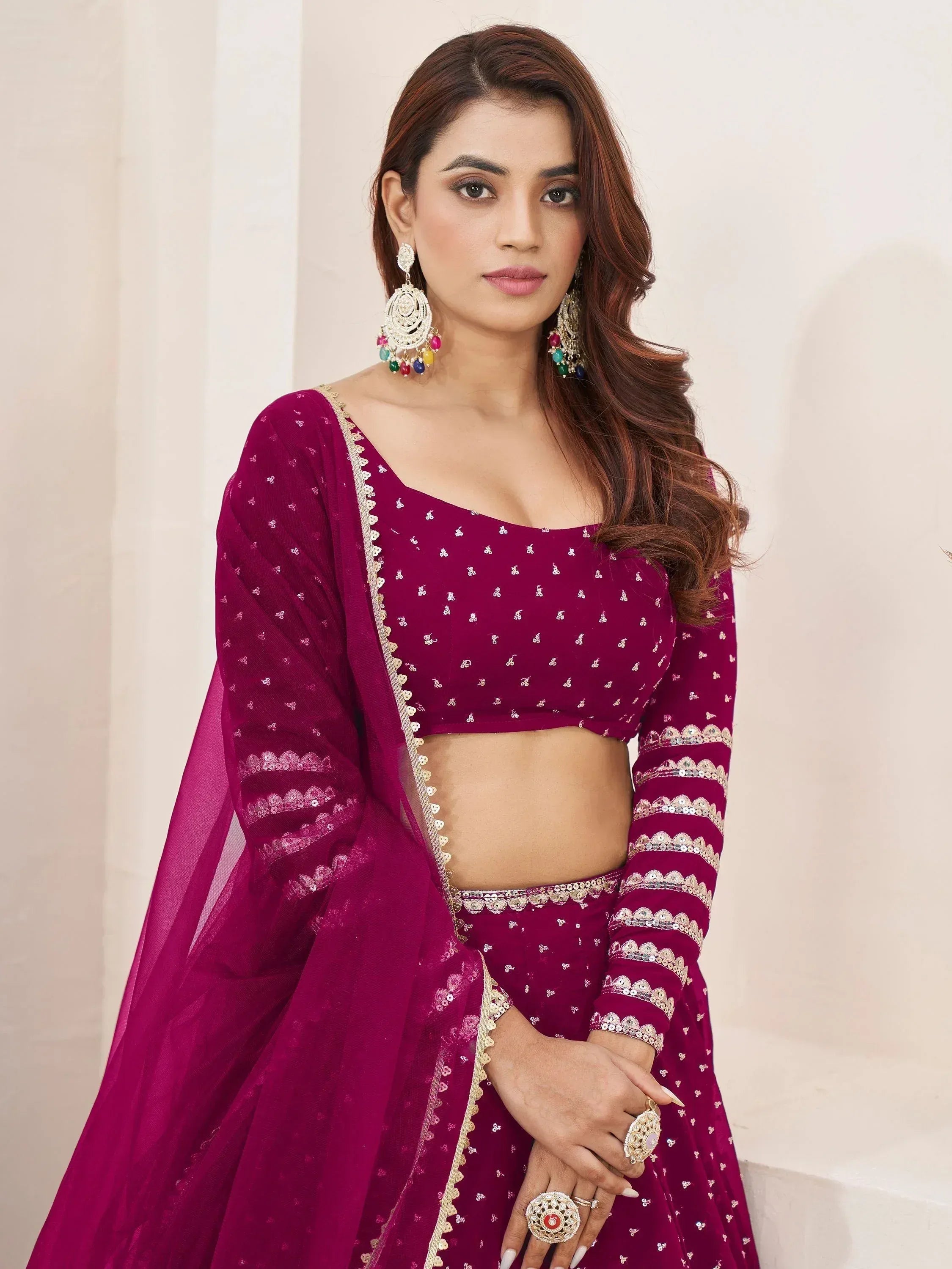Elegant maroon Indian lehenga choli with gold embroidery and sequins, perfect for weddings and festive occasions.