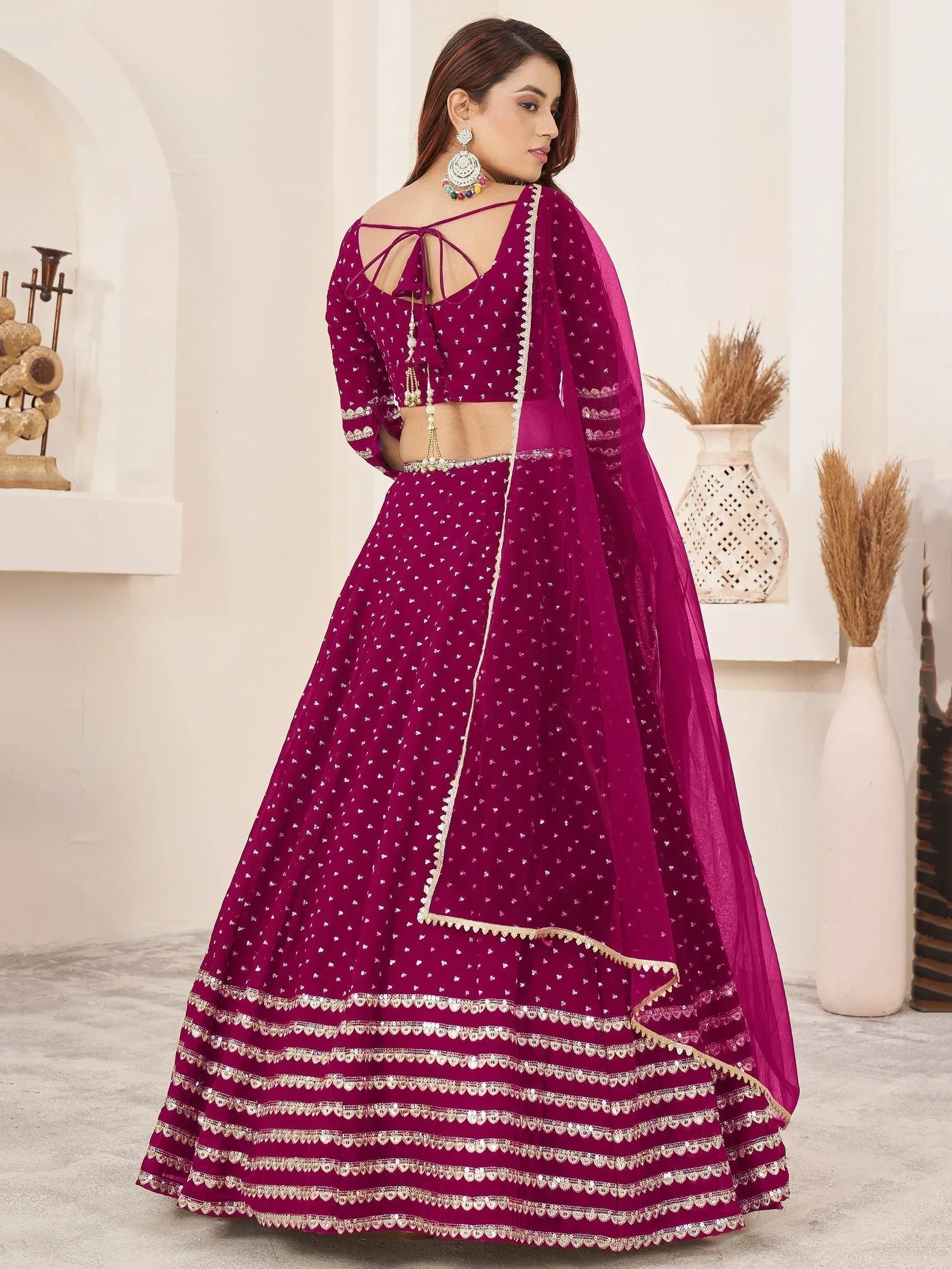Magenta designer lehenga choli with gold embroidery, back tie blouse, and sheer dupatta for Indian ethnic wear
