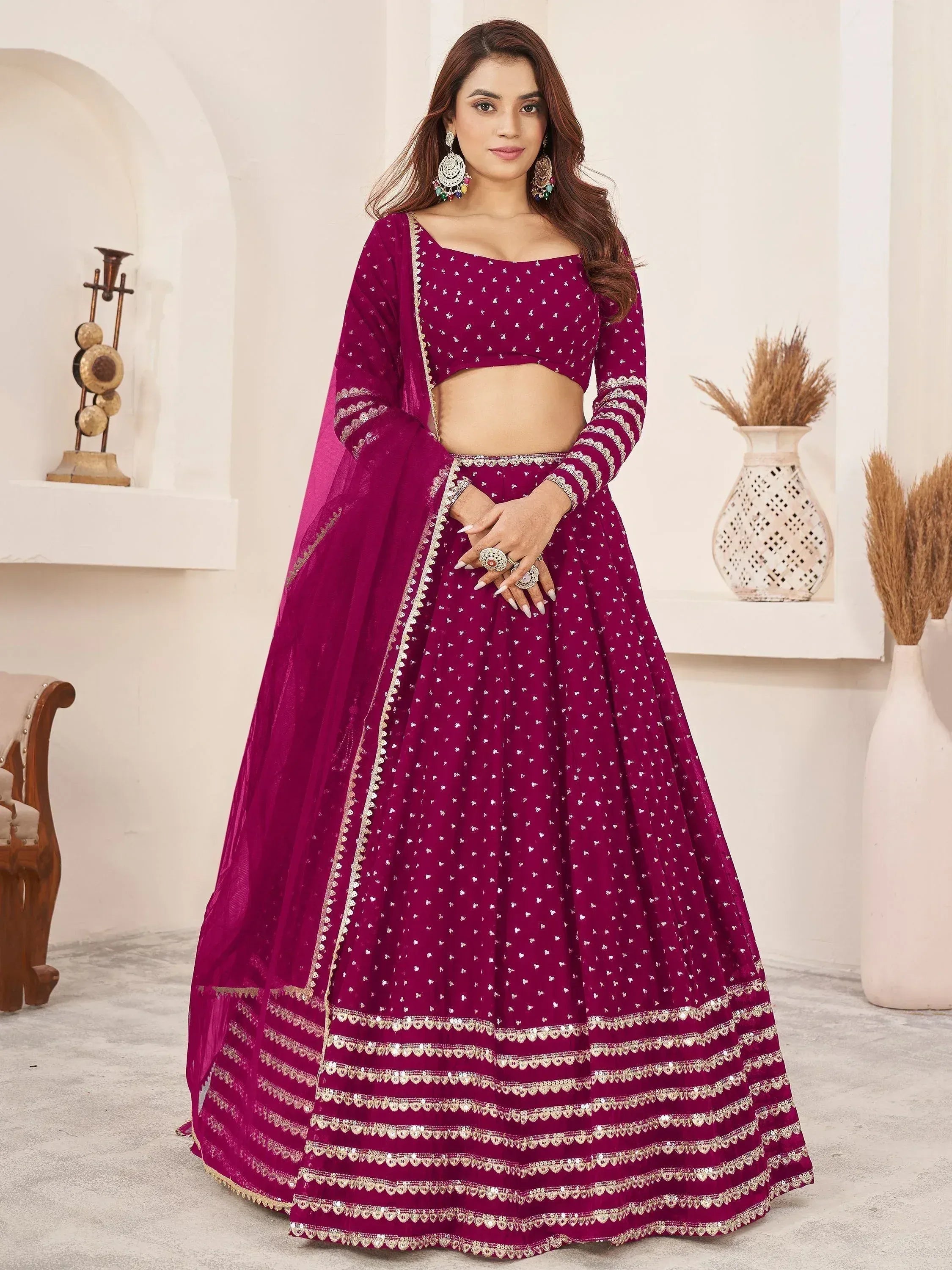 Elegant maroon lehenga choli with gold embroidery, perfect for Indian weddings and festive occasions.