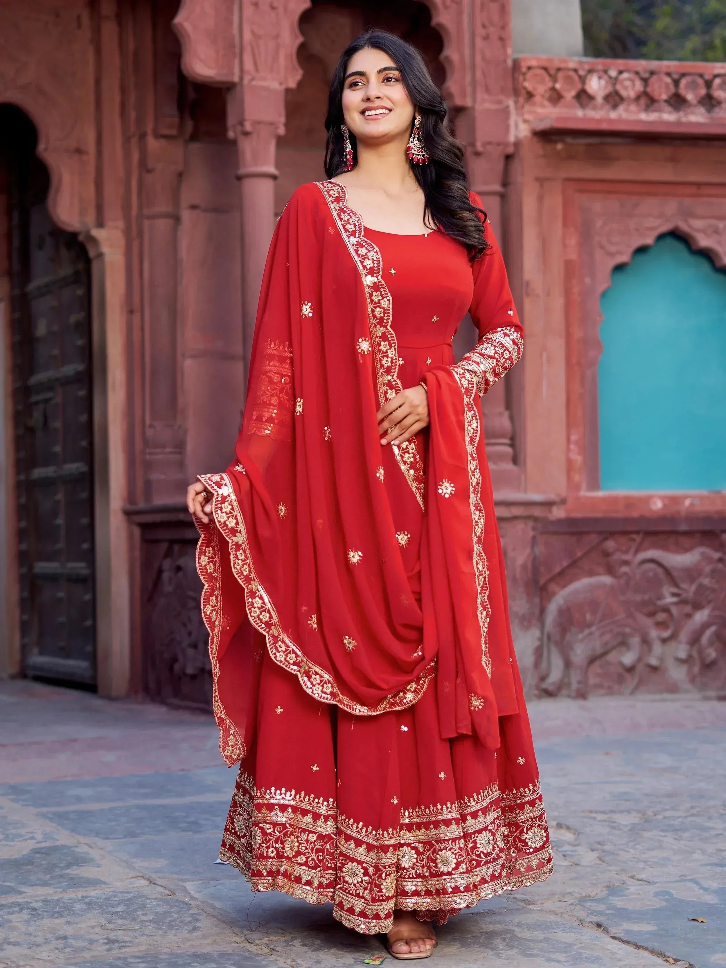 Red embroidered ethnic anarkali suit with gold detailing, perfect for Indian festive occasions