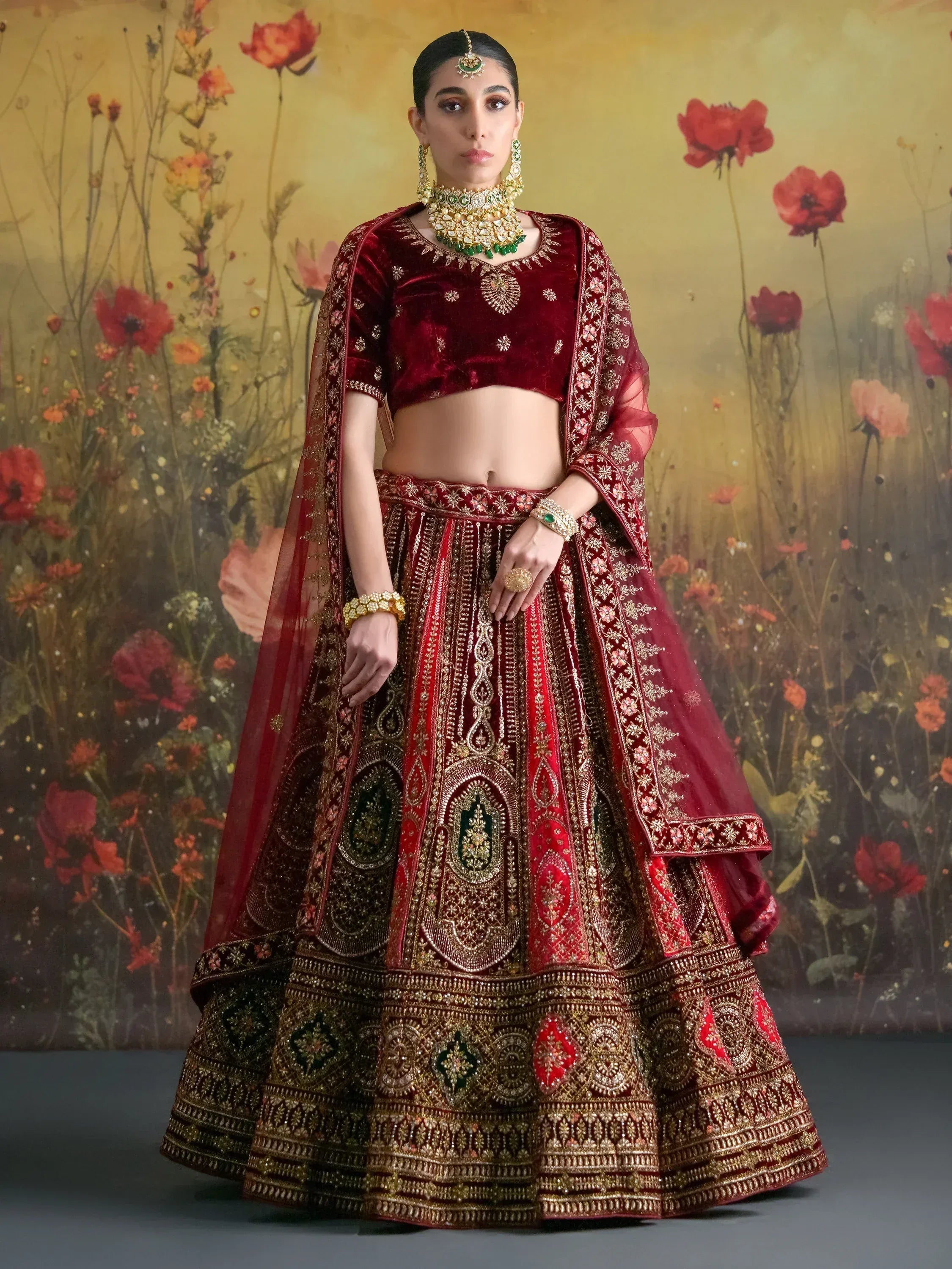 Maroon velvet lehenga choli with gold embroidery, perfect for Indian weddings and festive occasions.