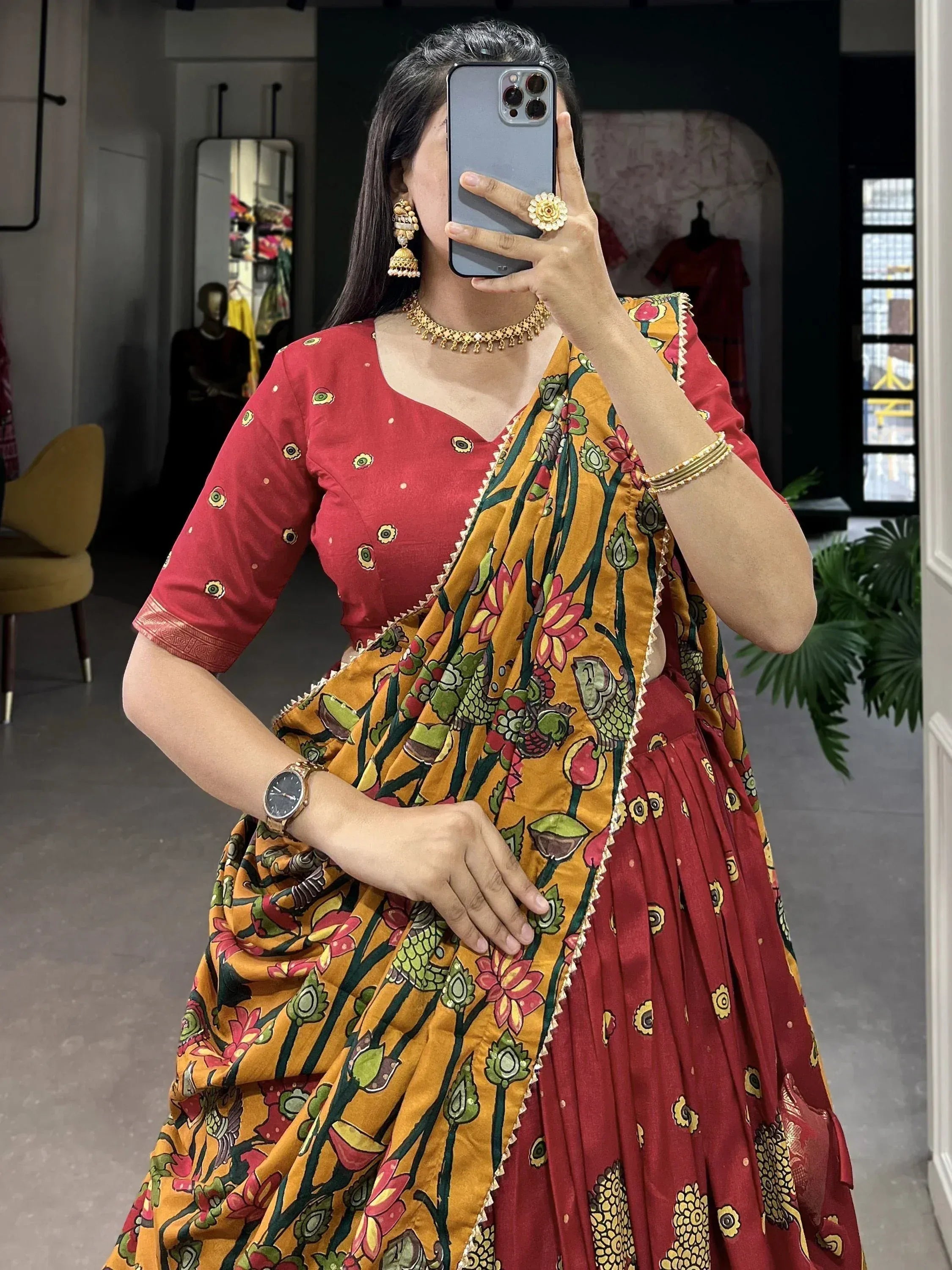 Woman in red lehenga choli with yellow floral dupatta, traditional Indian ethnic wear