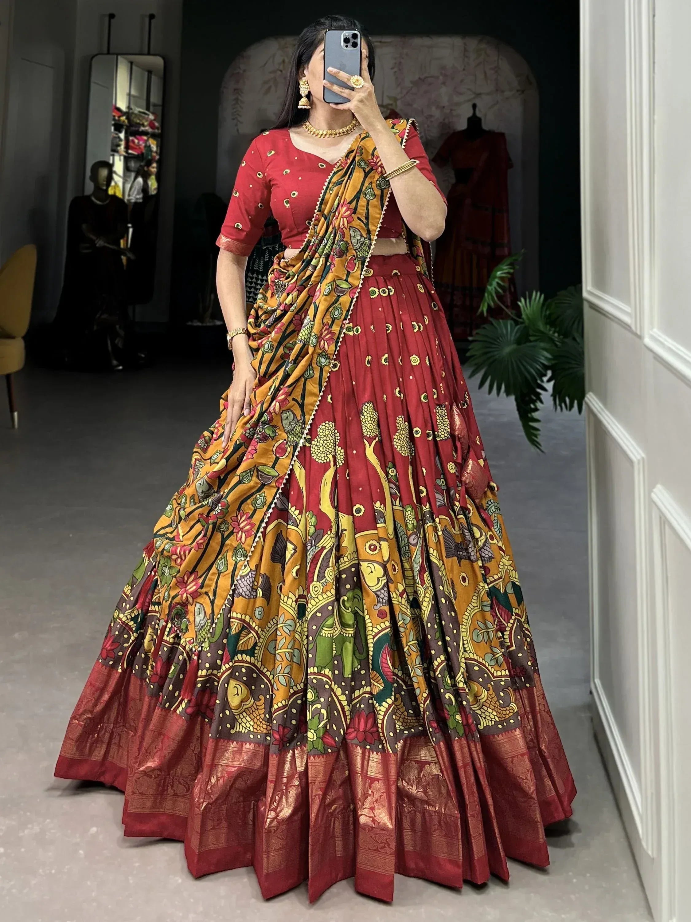 Red and yellow printed lehenga choli with floral and elephant motifs, ethnic Indian wear