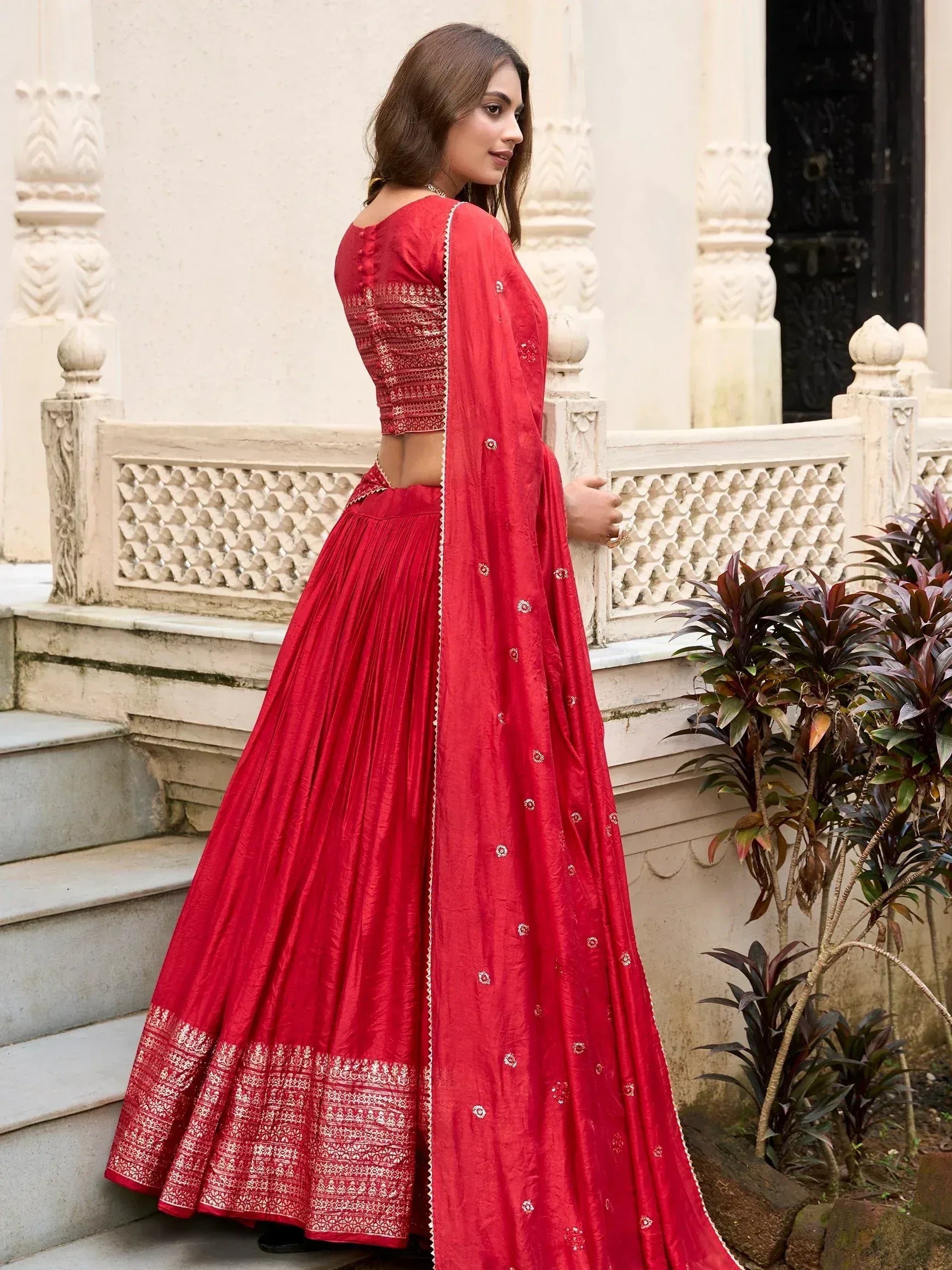 Red designer lehenga choli with gold embroidery, perfect for Indian weddings and festive occasions