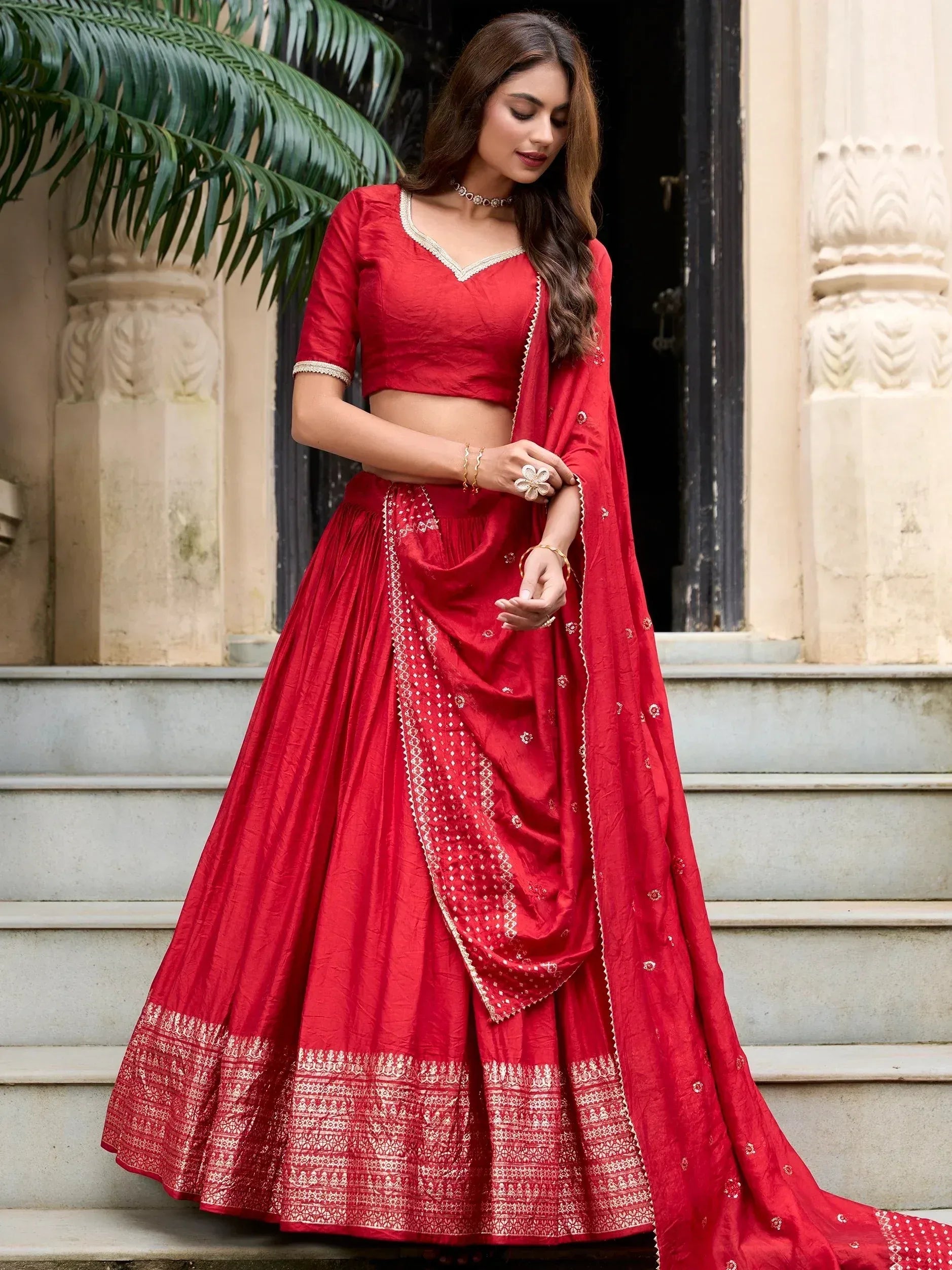 Red designer lehenga choli with gold embroidery, perfect for Indian weddings and festive occasions