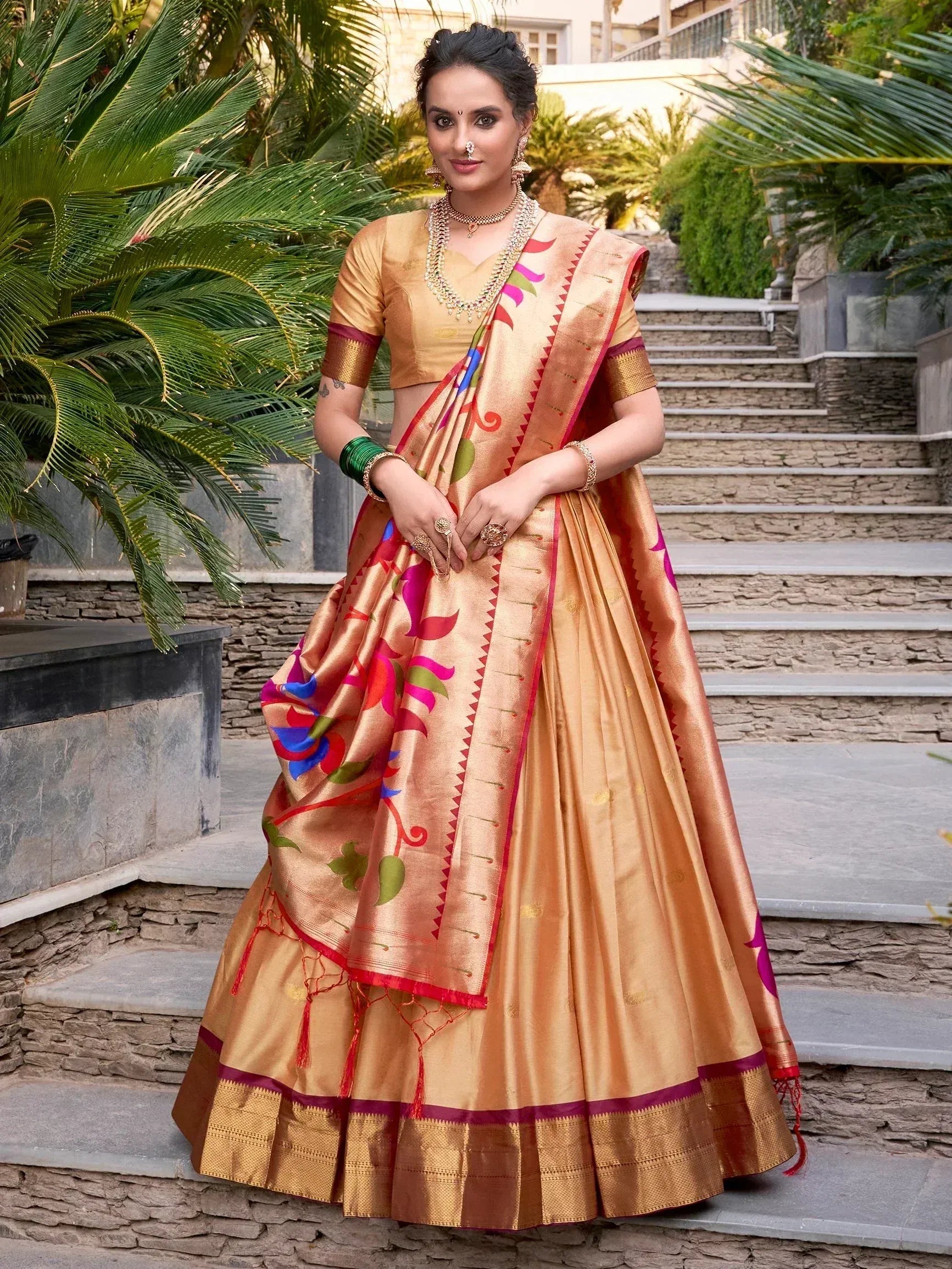 Woman in golden lehenga choli with colorful floral print, traditional Indian ethnic wear for festive occasions