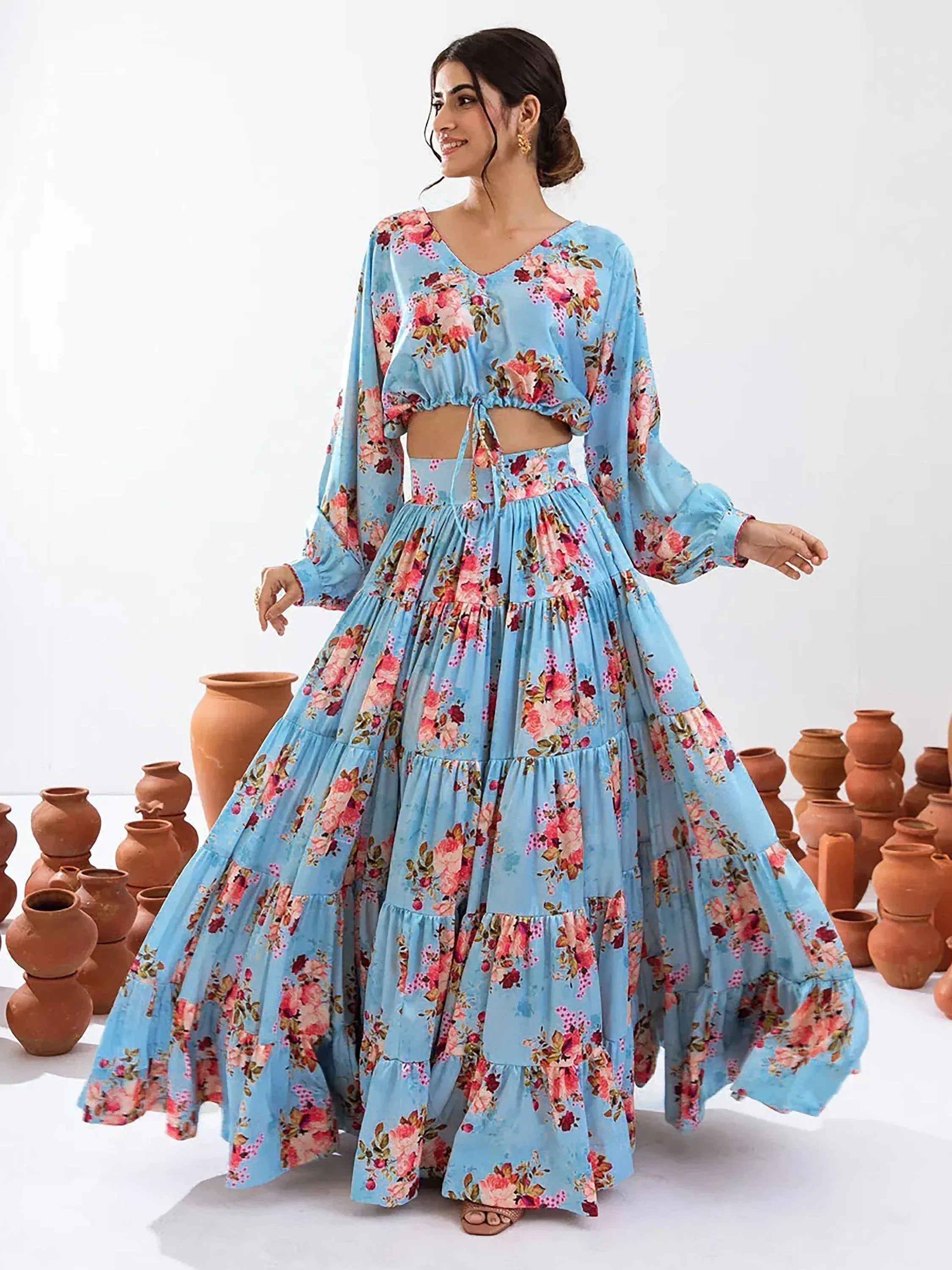 Blue floral print ethnic gown with tiered skirt and long sleeves, perfect for festive occasions.