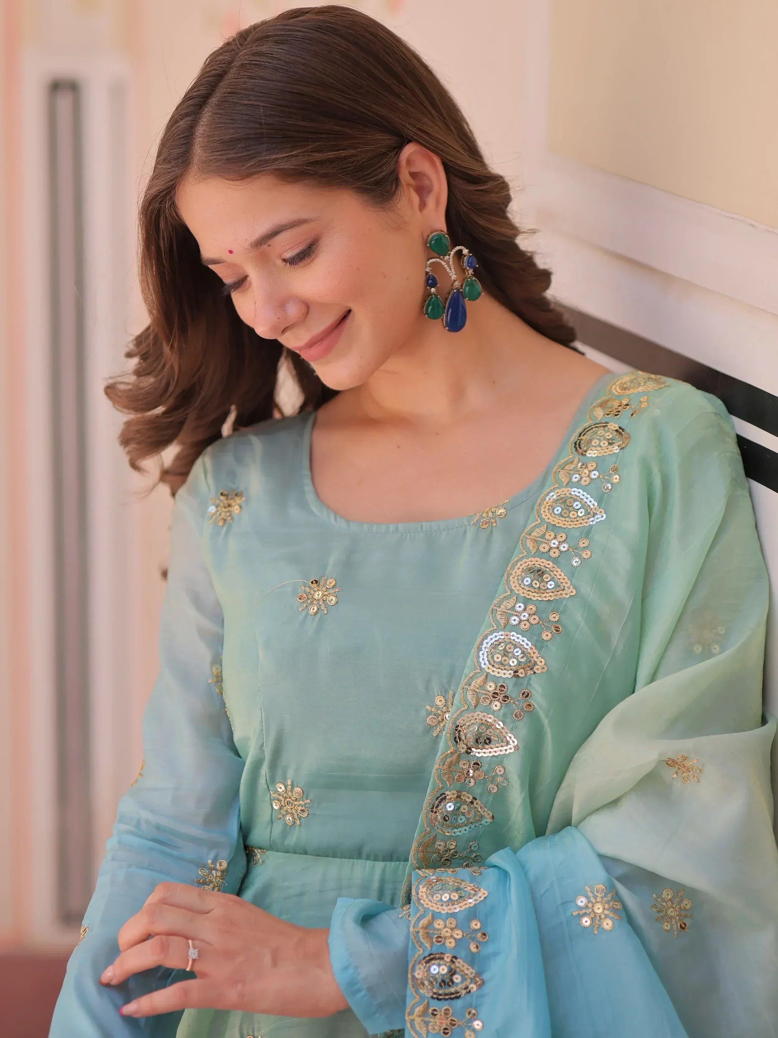 Mint green ethnic kurta with gold sequin embroidery and matching dupatta, styled with statement earrings.