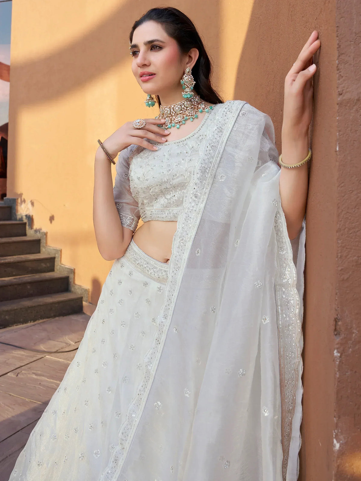 Elegant white embroidered lehenga choli with sheer dupatta, perfect for Indian ethnic occasions