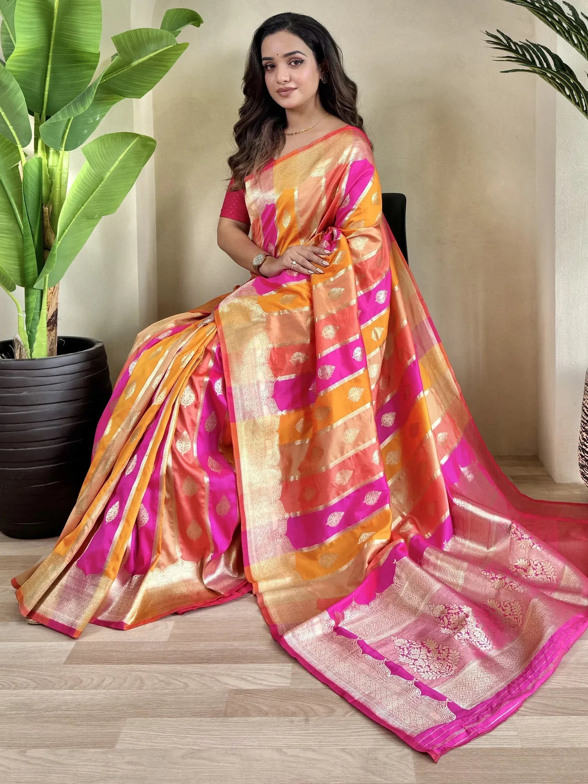 Vibrant pink and orange designer saree with gold zari work, perfect for Indian ethnic wear occasions