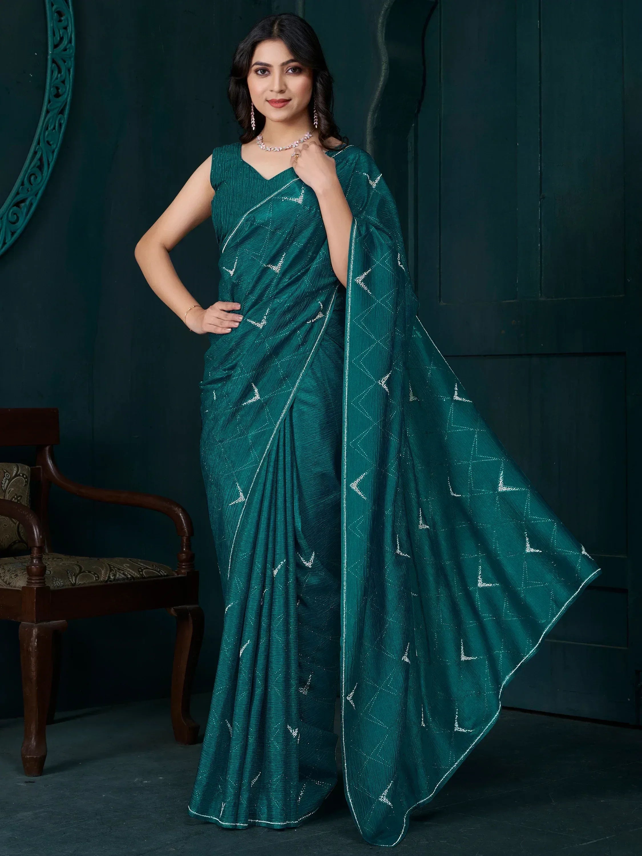 Emerald green ethnic saree with silver geometric embroidery, perfect for Indian occasions and festive wear.