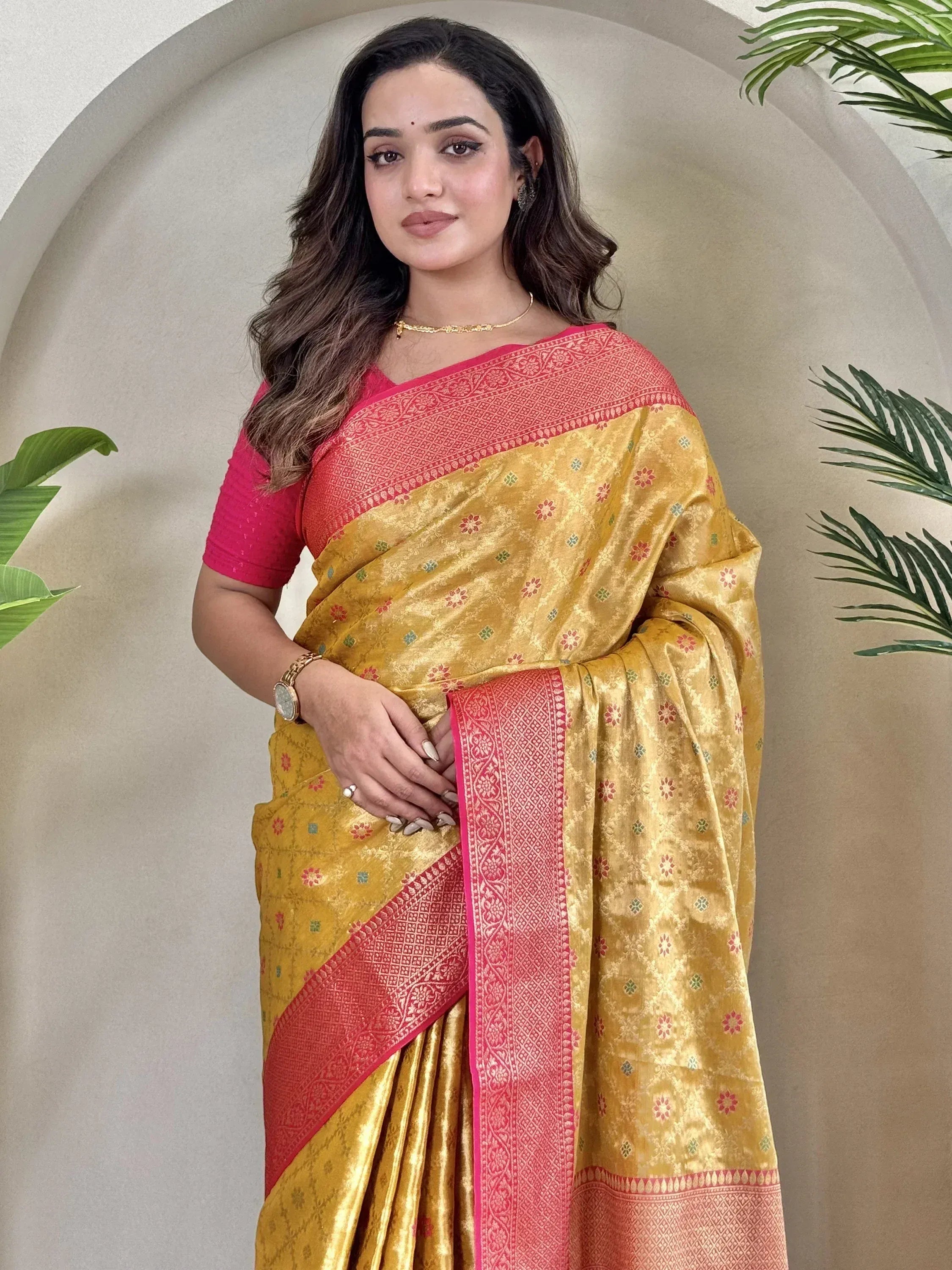 Yellow and pink designer saree with floral motifs and woven border, perfect for ethnic occasions