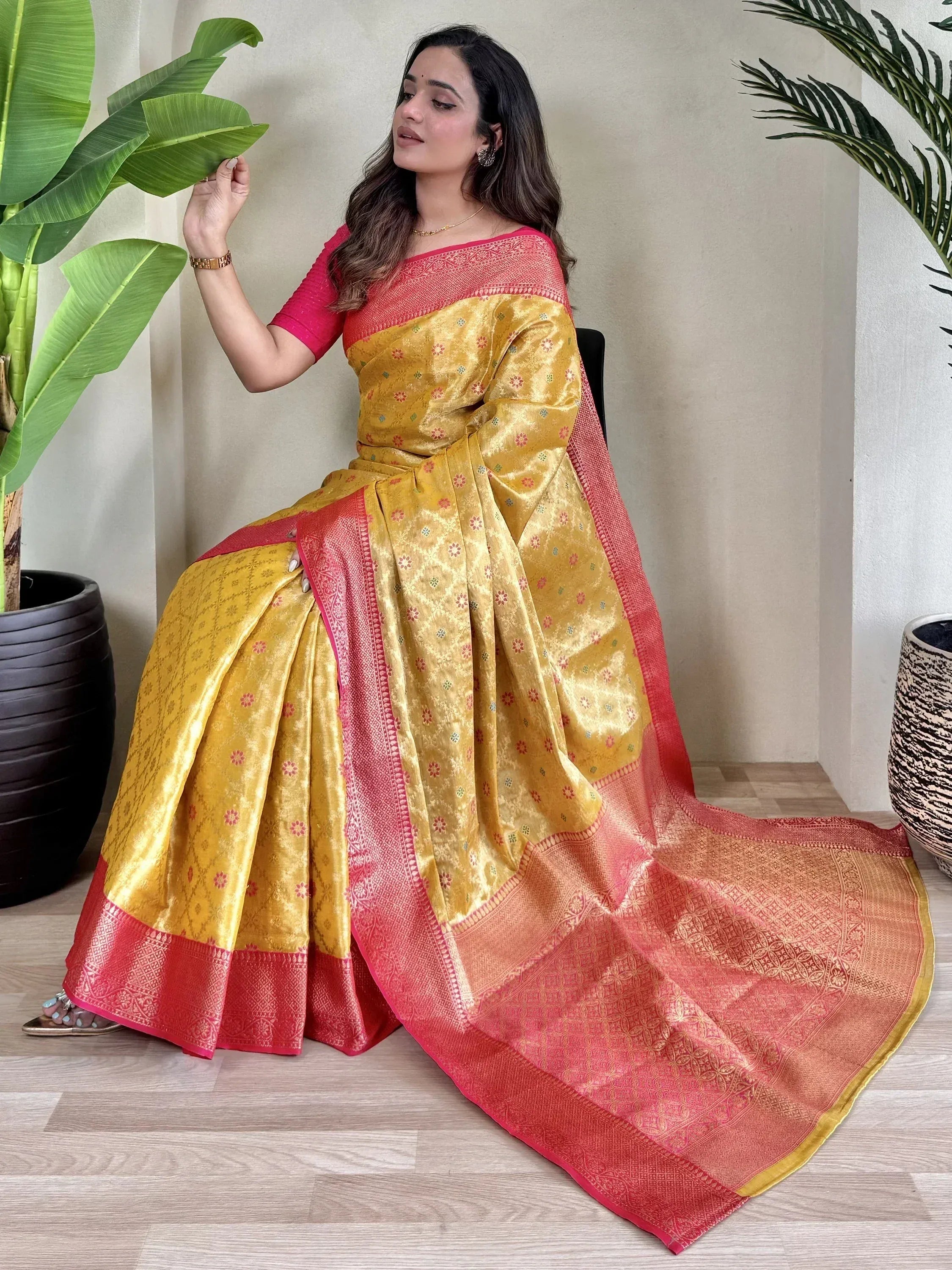 Yellow and pink designer saree with floral motifs and woven border, perfect for ethnic occasions