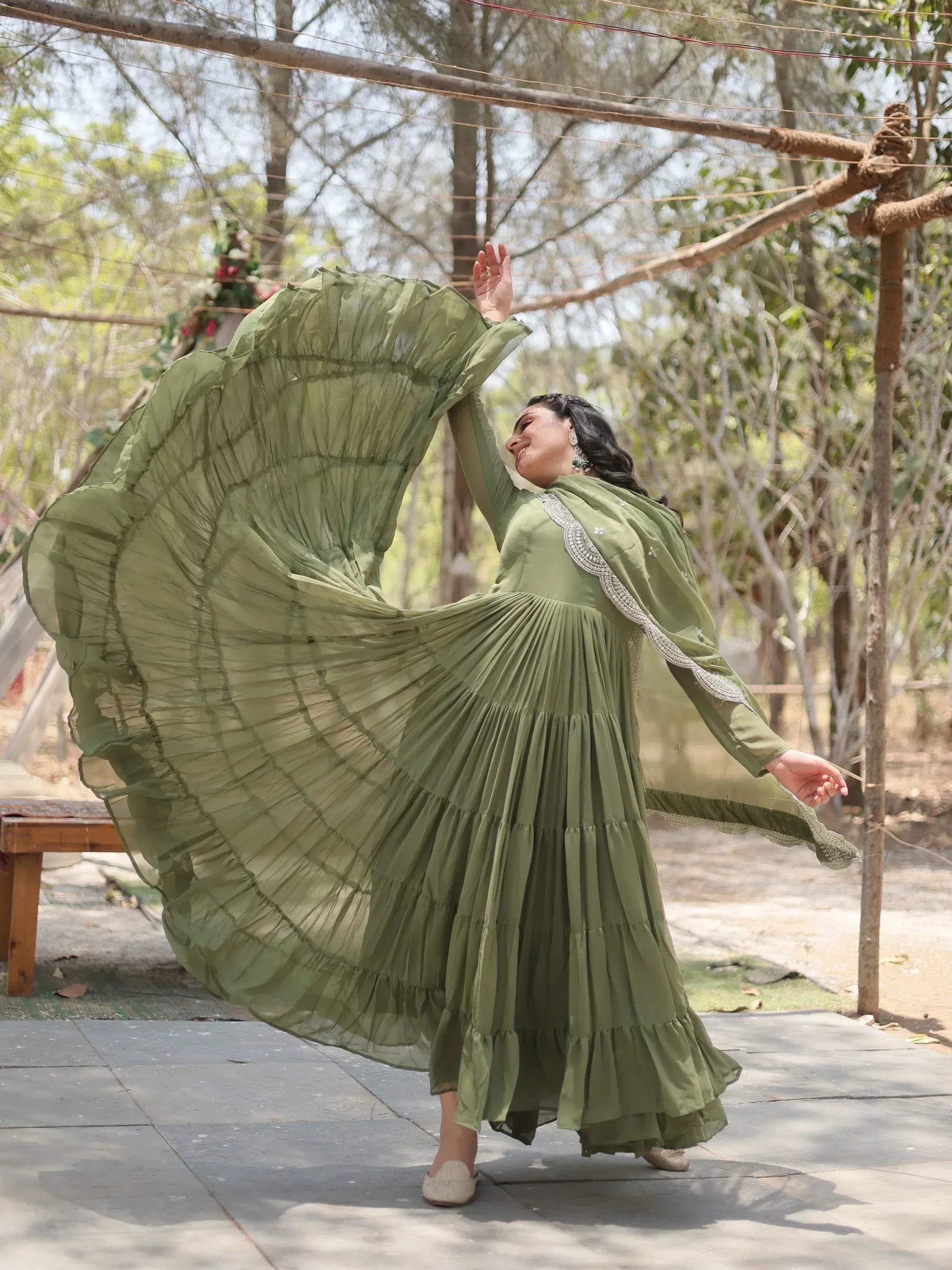 Olive green ethnic gown with ruffled sleeves and pleated skirt, perfect for festive occasions.