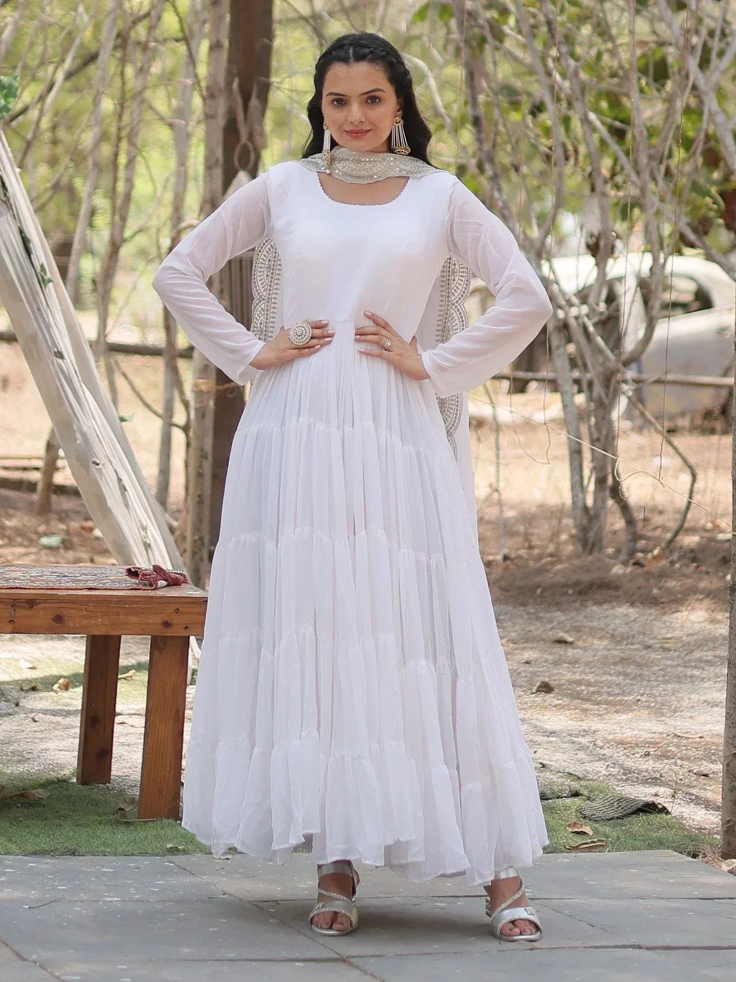 White ethnic gown with embroidered neckline and tiered skirt, perfect for Indian festive occasions