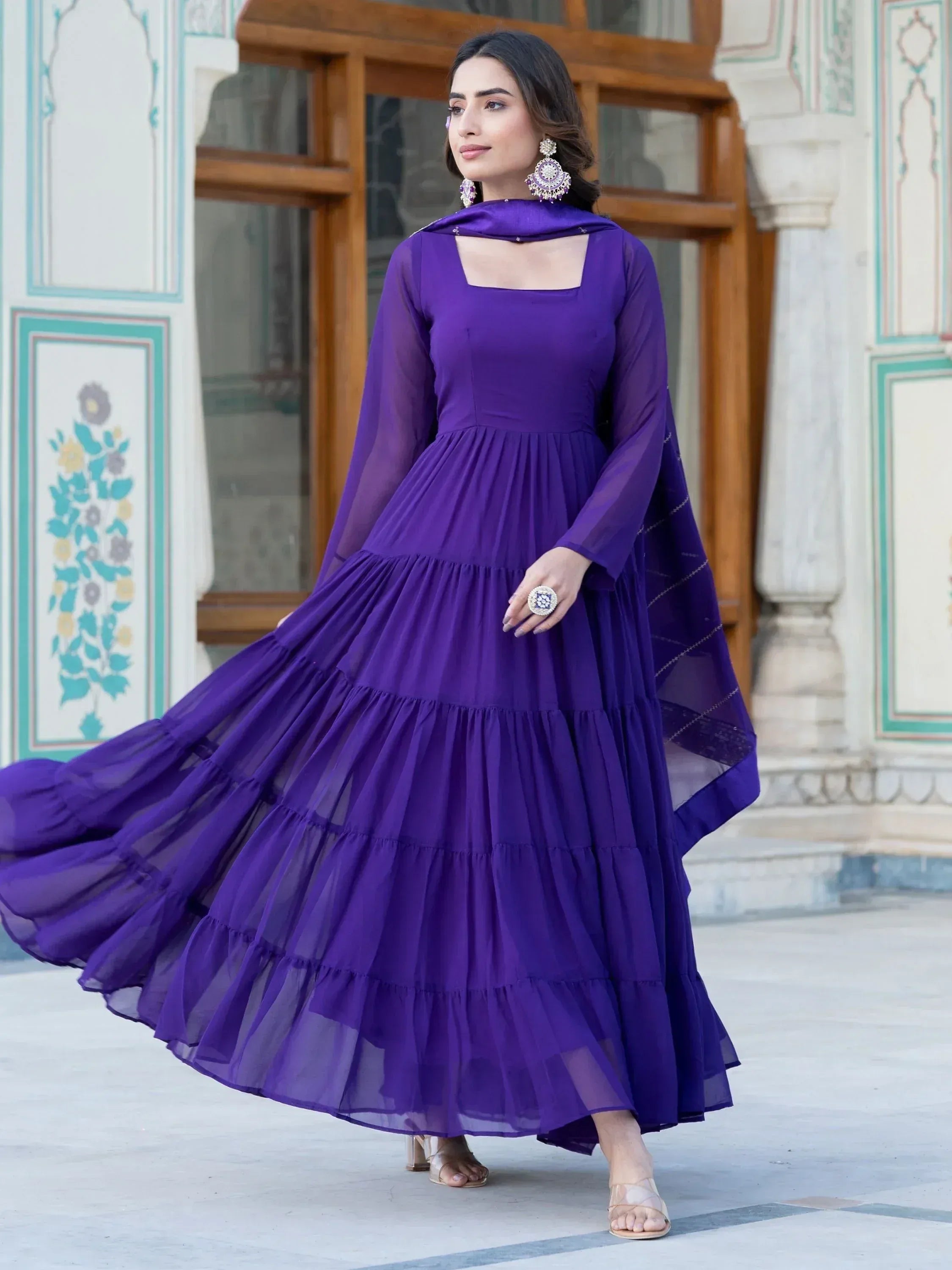 Elegant purple tiered ethnic gown with sheer sleeves and matching dupatta for festive occasions