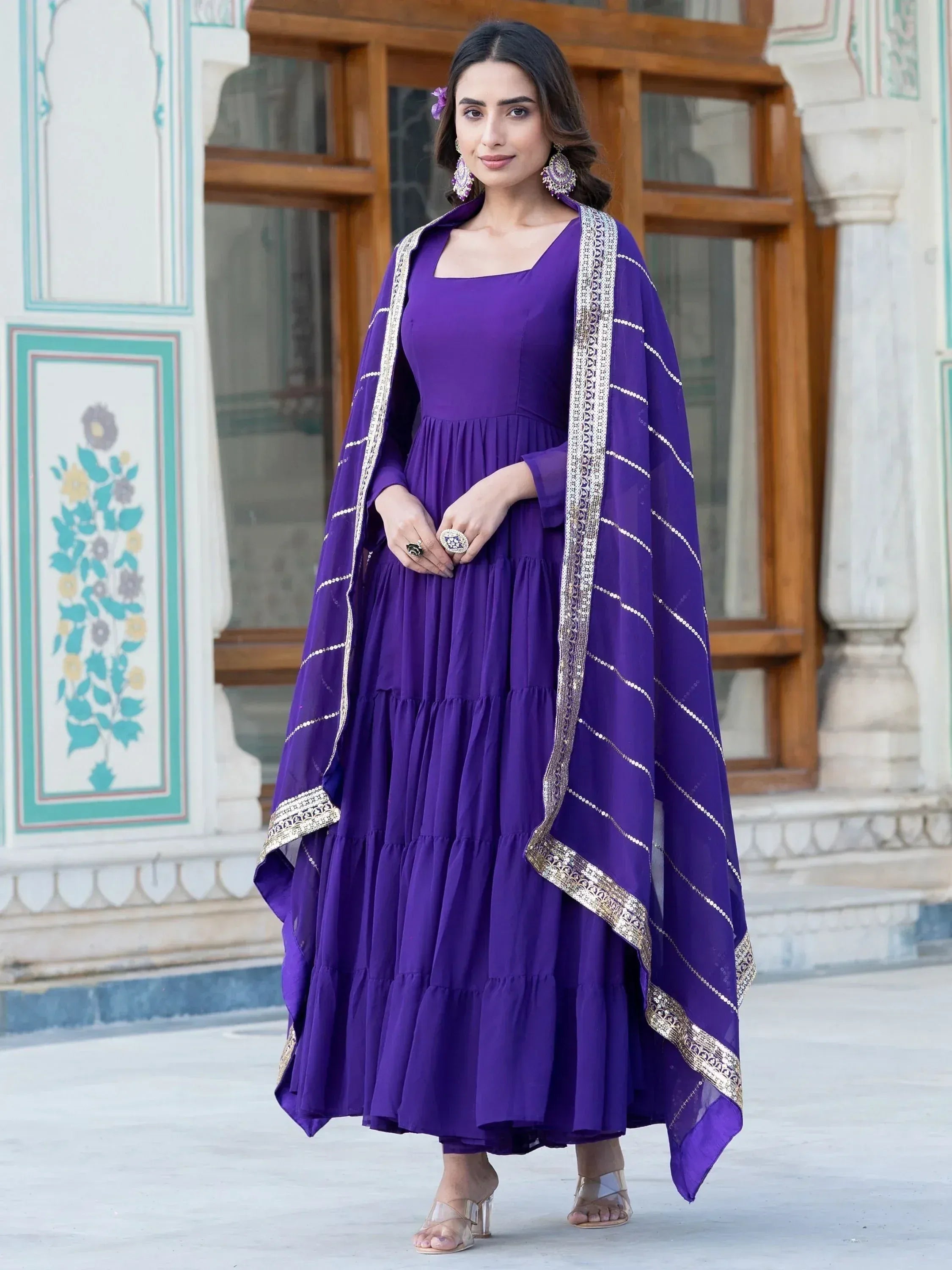 Purple tiered ethnic gown with gold trim and matching dupatta, perfect for Indian festive occasions